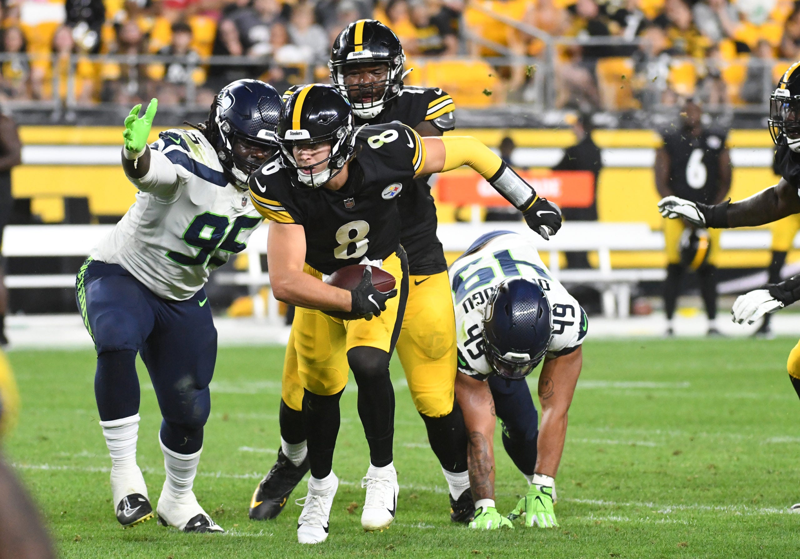 Aug 13, 2022; Pittsburgh, Pennsylvania, USA;  Pittsburgh Steelers quarterback Kenny Pickett (8) is pressured by Seattle Seahawks defensive tackle Myles Adams (95) and linebacker Joshua Onujiogu (49) during the fourth quarter at Acrisure Stadium. Mandatory Credit: Philip G. Pavely-USA TODAY Sports
