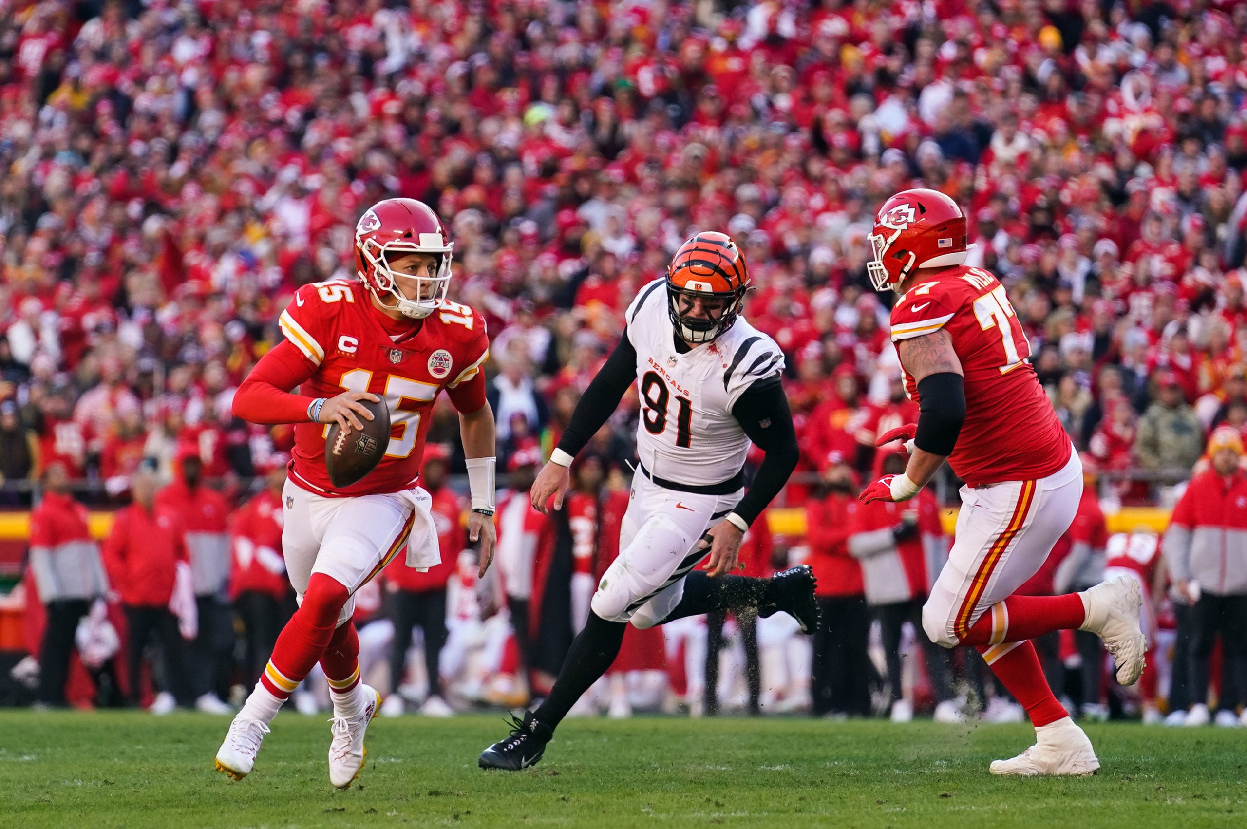 Jan 30, 2022; Kansas City, Missouri, USA; Kansas City Chiefs quarterback Patrick Mahomes (15) and Cincinnati Bengals defensive end Trey Hendrickson (91) during the first half of the AFC Championship game at GEHA Field at Arrowhead Stadium. Mandatory Credit: Jay Biggerstaff-USA TODAY Sports