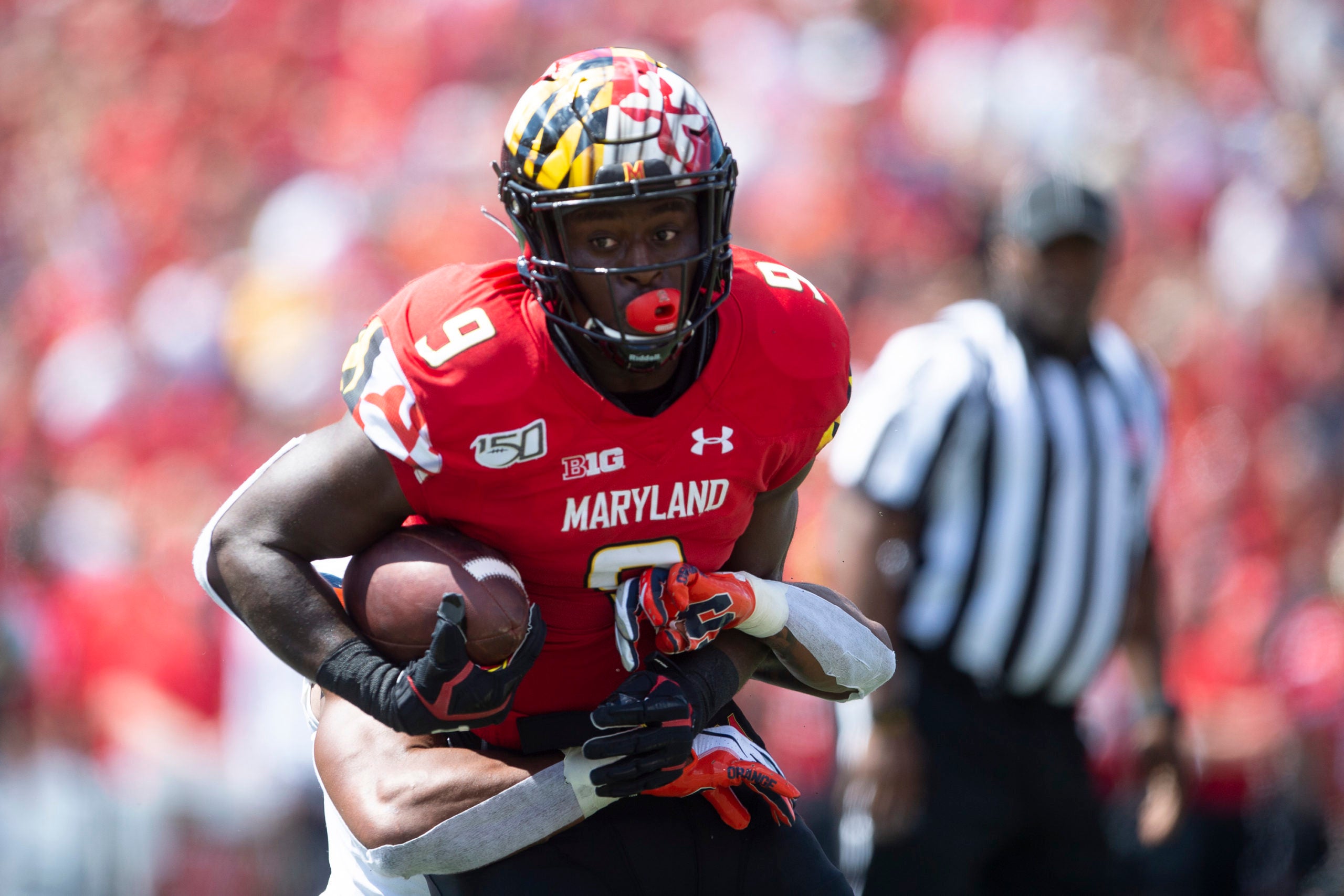 Sep 7, 2019; College Park, MD, USA; Maryland Terrapins tight end Chigoziem Okonkwo (9) runs with the ball as Syracuse Orange defensive back Eric Coley (34) tackles during the first quarter at Capital One Field at Maryland Stadium. Mandatory Credit: Tommy Gilligan-USA TODAY Sports