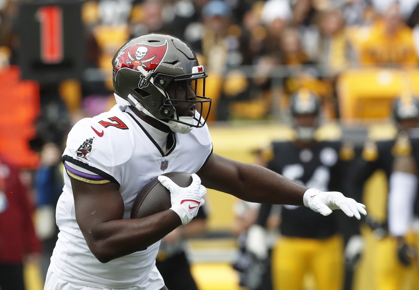 Oct 16, 2022; Pittsburgh, Pennsylvania, USA; Tampa Bay Buccaneers running back Leonard Fournette (7) carries the ball against the Pittsburgh Steelers during the first quarter at Acrisure Stadium. Mandatory Credit: Charles LeClaire-USA TODAY Sports