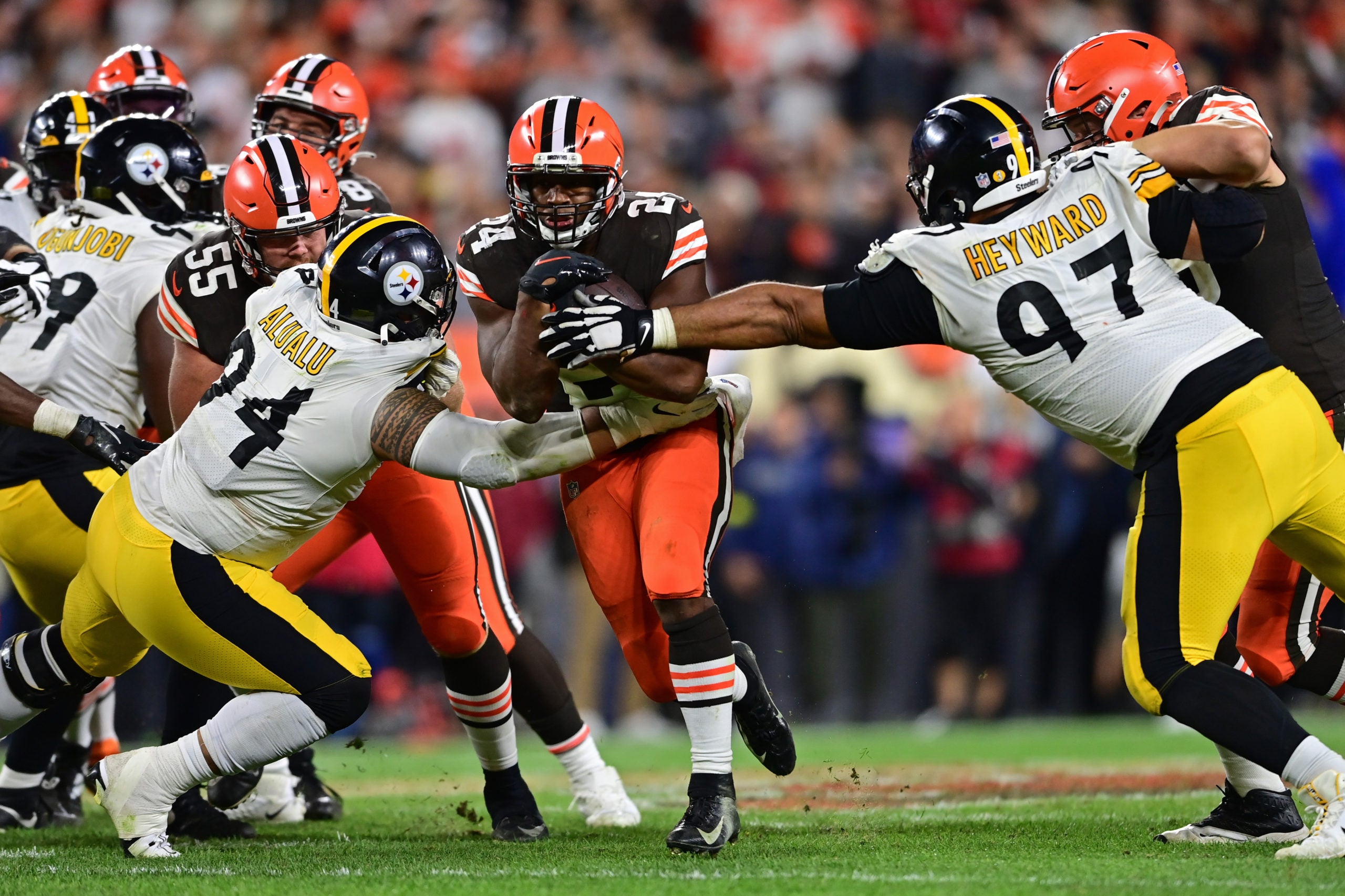 Sep 22, 2022; Cleveland, Ohio, USA; Cleveland Browns running back Nick Chubb (24) runs the ball between Pittsburgh Steelers defensive end Tyson Alualu (94) and defensive tackle Cameron Heyward (97) during the fourth quarter at FirstEnergy Stadium. Mandatory Credit: David Dermer-USA TODAY Sports