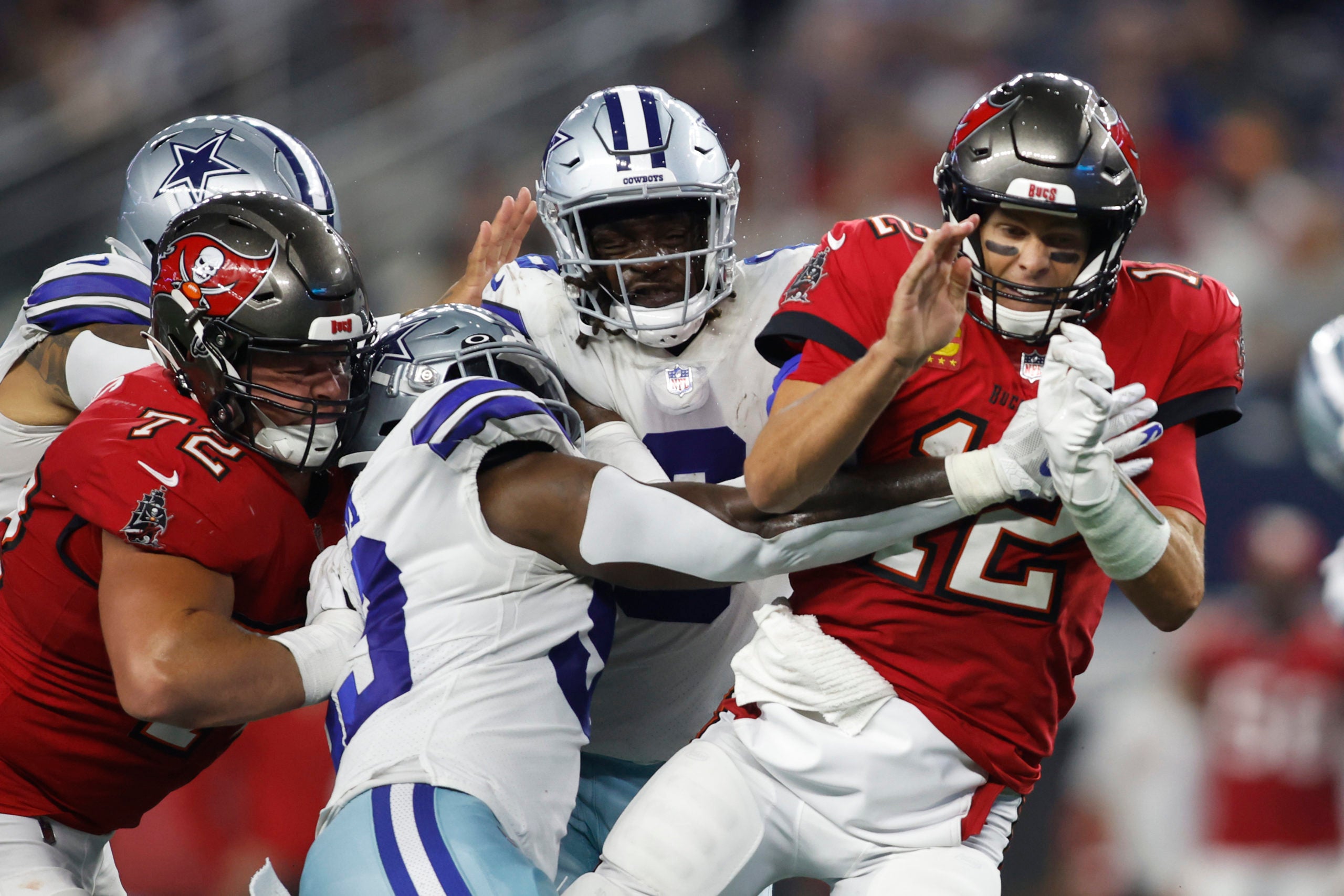 Sep 11, 2022; Arlington, Texas, USA; Dallas Cowboys defensive end Tarell Basham (93) hits Tampa Bay Buccaneers quarterback Tom Brady (12) after he throws a pass in the fourth quarter at AT&T Stadium. Mandatory Credit: Tim Heitman-USA TODAY Sports