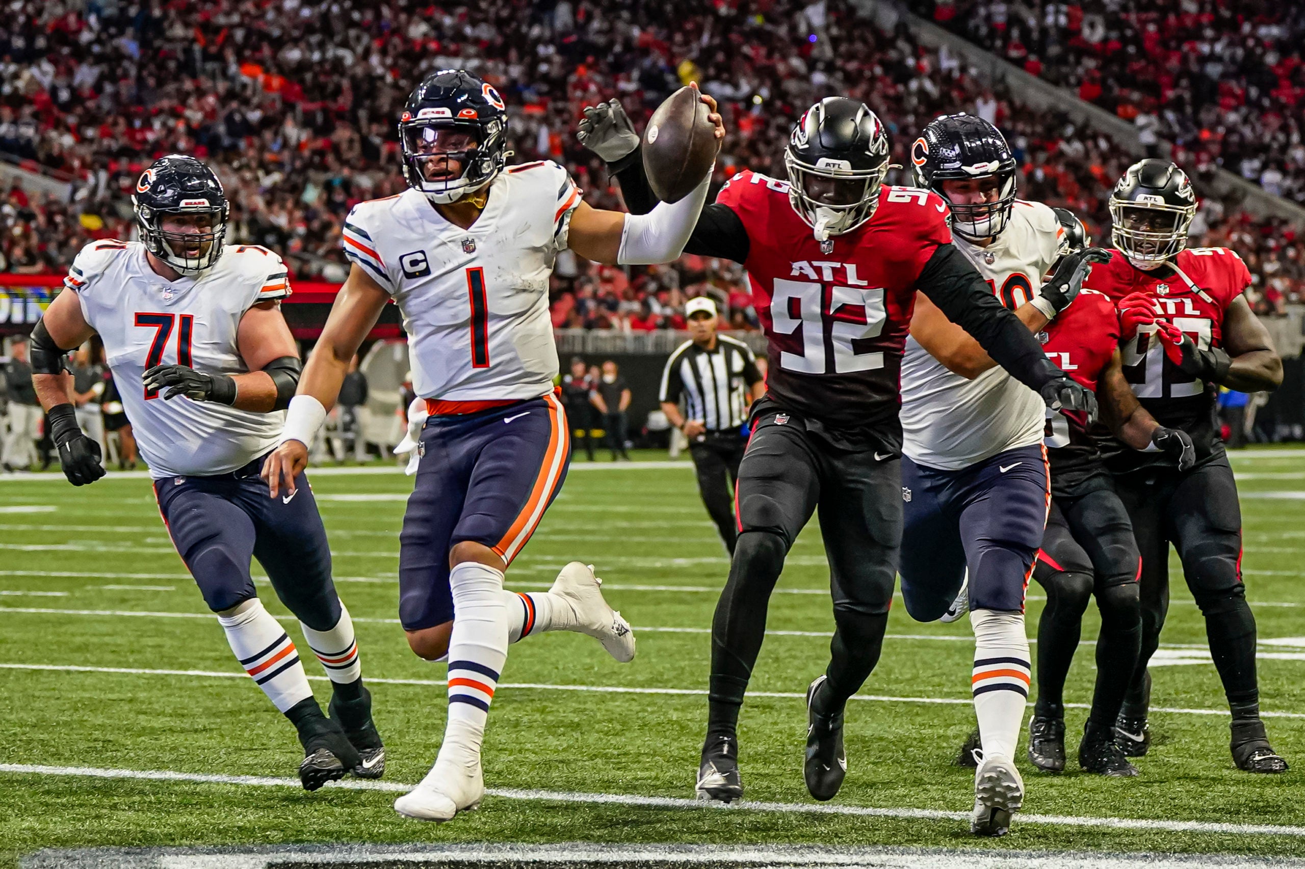 Nov 20, 2022; Atlanta, Georgia, USA; Chicago Bears quarterback Justin Fields (1) runs for a touchdown against the Atlanta Falcons at Mercedes-Benz Stadium. Mandatory Credit: Dale Zanine-USA TODAY Sports