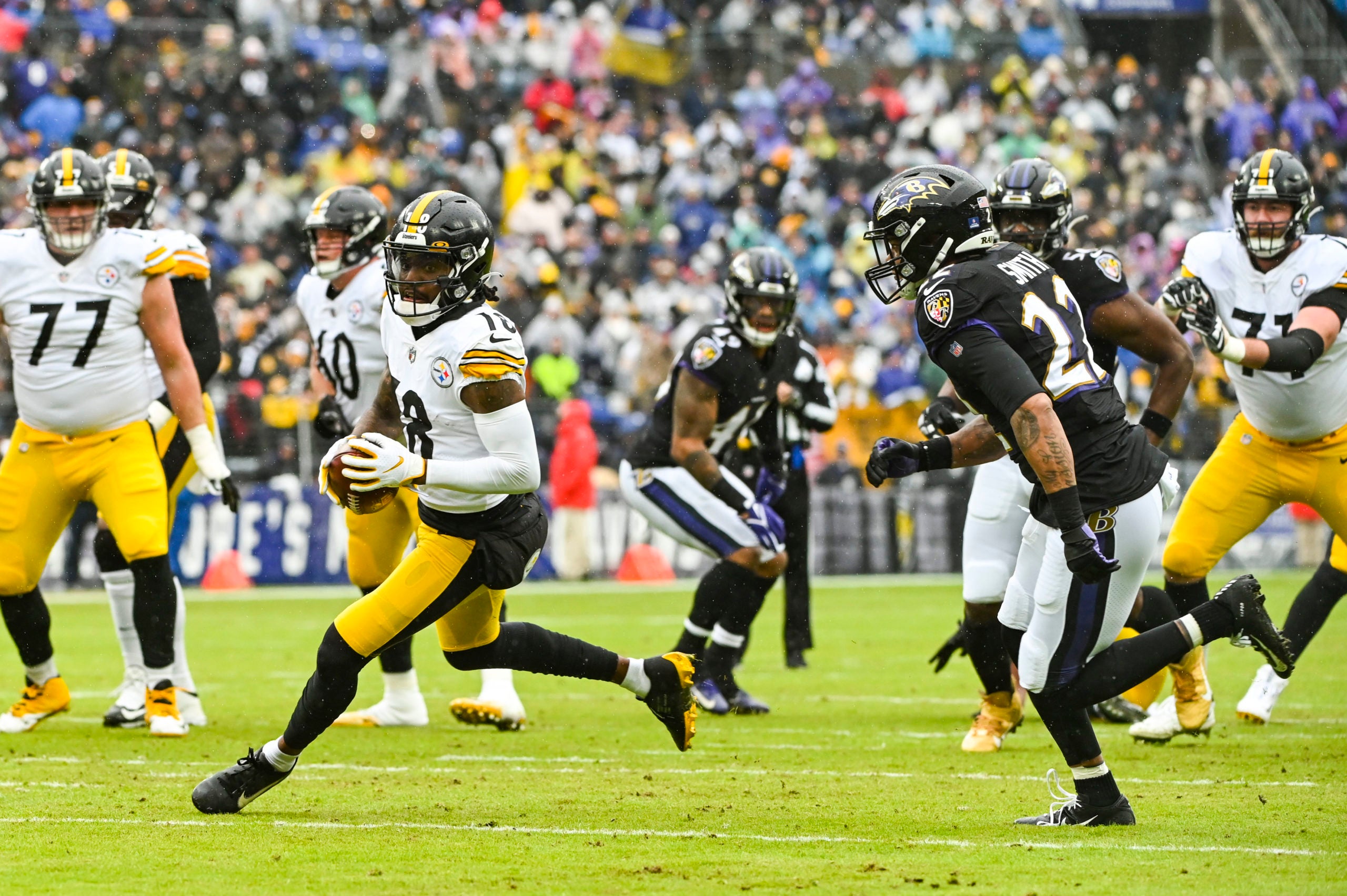 Jan 9, 2022; Baltimore, Maryland, USA; Pittsburgh Steelers wide receiver Diontae Johnson (18) runs after a catch as Baltimore Ravens cornerback Jimmy Smith (22) defense during the first quarter at M&T Bank Stadium. Mandatory Credit: Tommy Gilligan-USA TODAY Sports