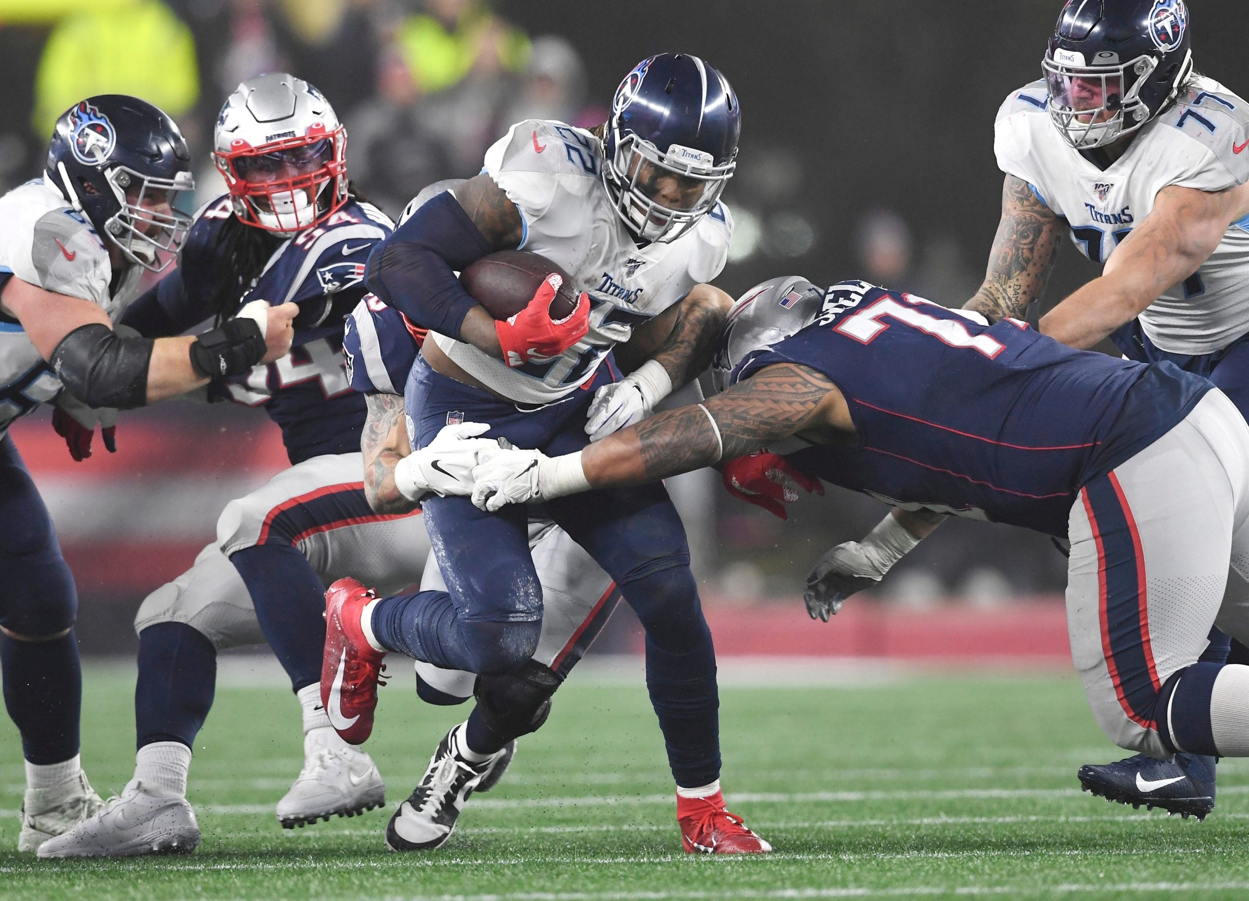 Tennessee Titans running back Derrick Henry (22) runs through the New England Patriots defense during the AFC Wild Card game at Gillette Stadium in Foxborough, Mass., Jan. 4, 2020. Gw55073
