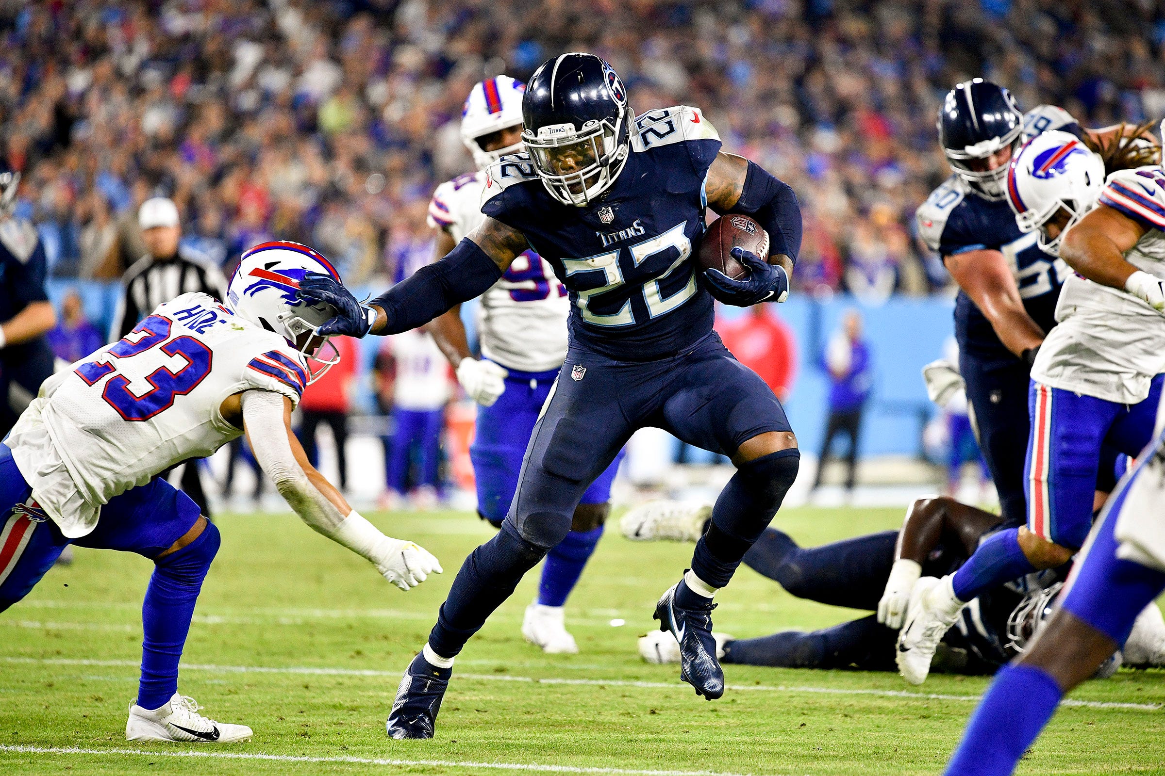 Tennessee Titans running back Derrick Henry (22) keeps Buffalo Bills safety Micah Hyde (23) at arms length as he runs for a touchdown at Nissan Stadium Monday, Oct. 18, 2021 in Nashville, Tenn. Titans Bills 279