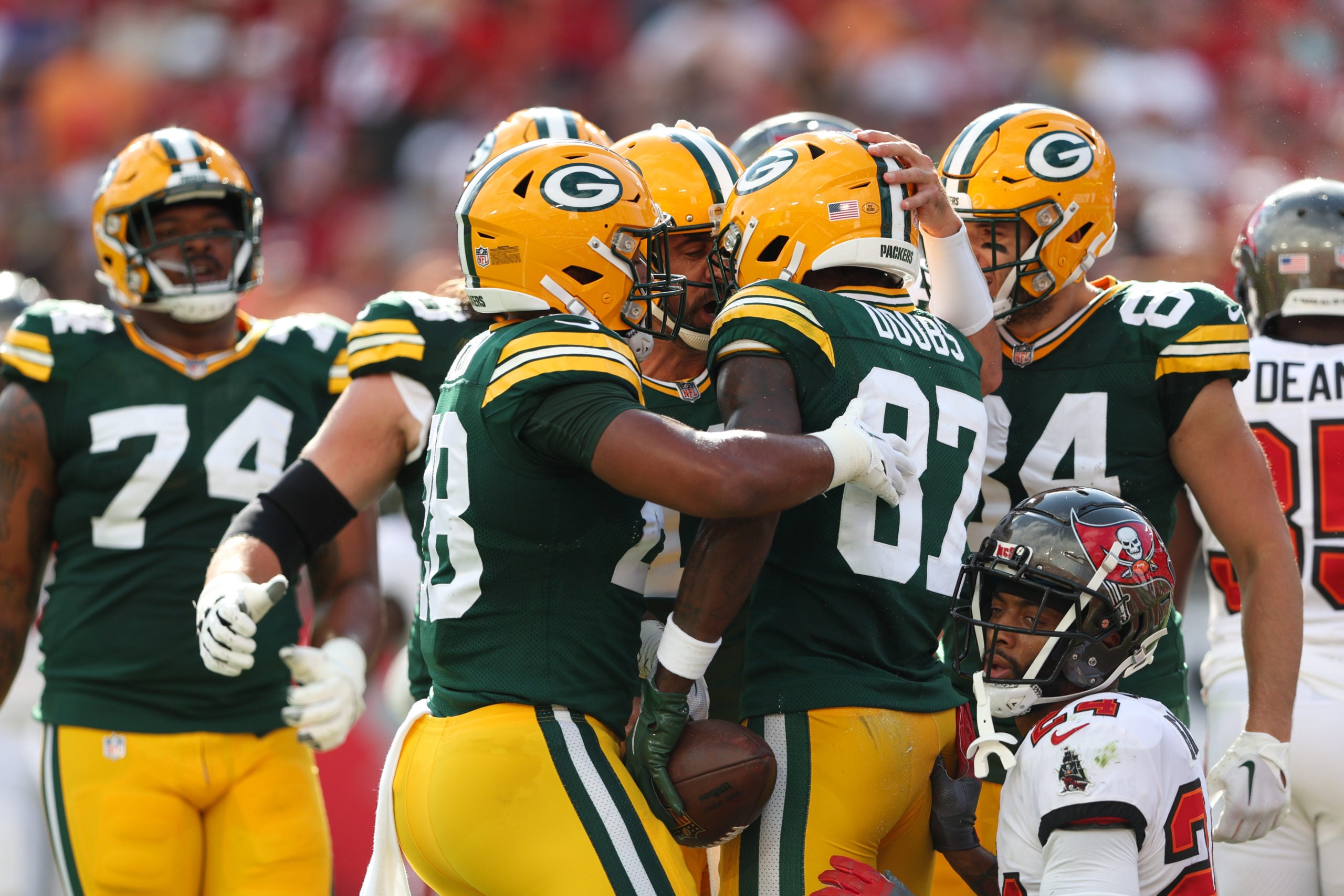 Sep 25, 2022; Tampa, Florida, USA; Green Bay Packers wide receiver Romeo Doubs (87) is congratulated by quarterback Aaron Rodgers (12) after scoring a touchdown against the Tampa Bay Buccaneers in the first quarterat Raymond James Stadium. Mandatory Credit: Nathan Ray Seebeck-USA TODAY Sports