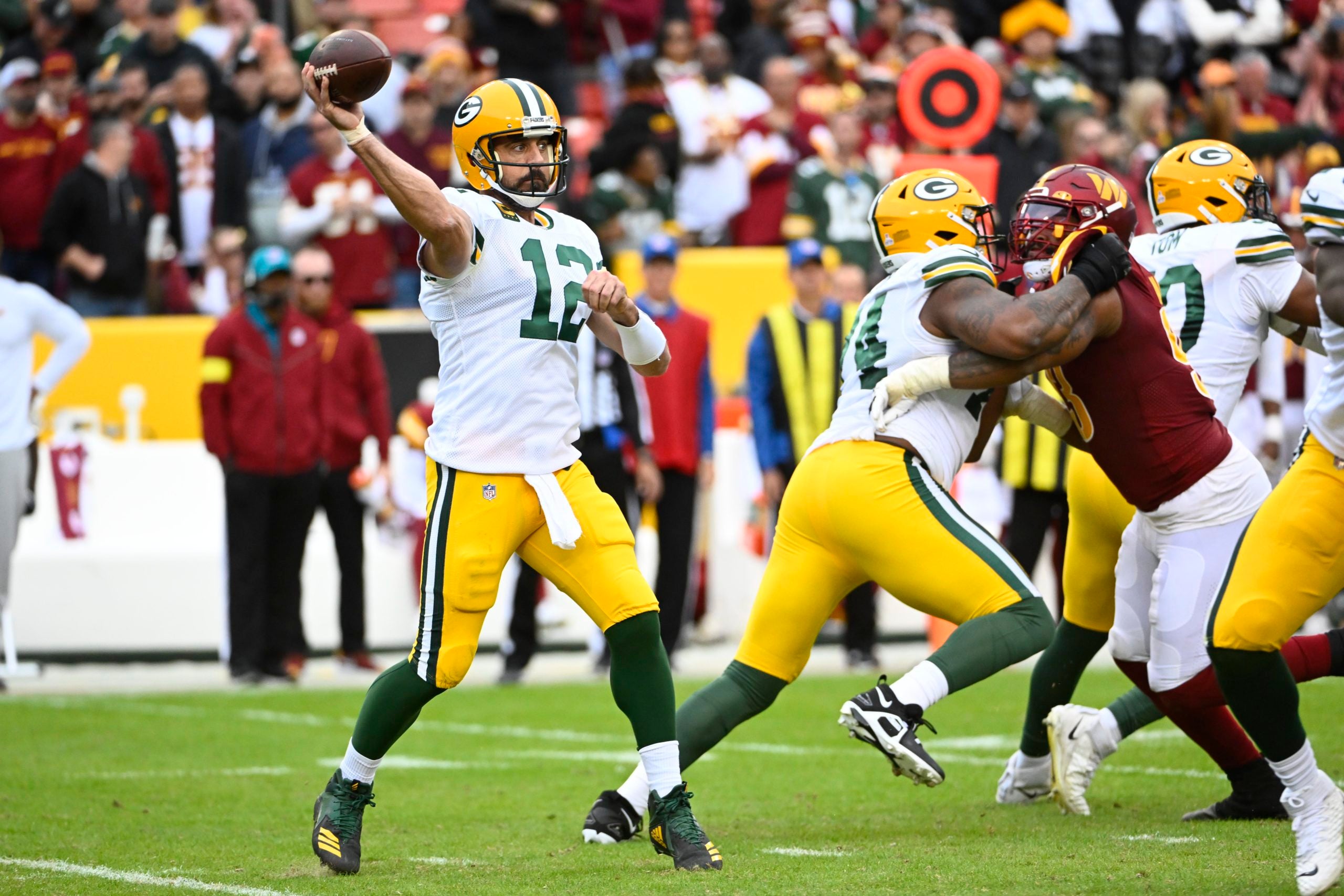 Oct 23, 2022; Landover, Maryland, USA; Green Bay Packers quarterback Aaron Rodgers (12) attempts a pass against the Washington Commanders during the second half at FedExField. Mandatory Credit: Brad Mills-USA TODAY Sports