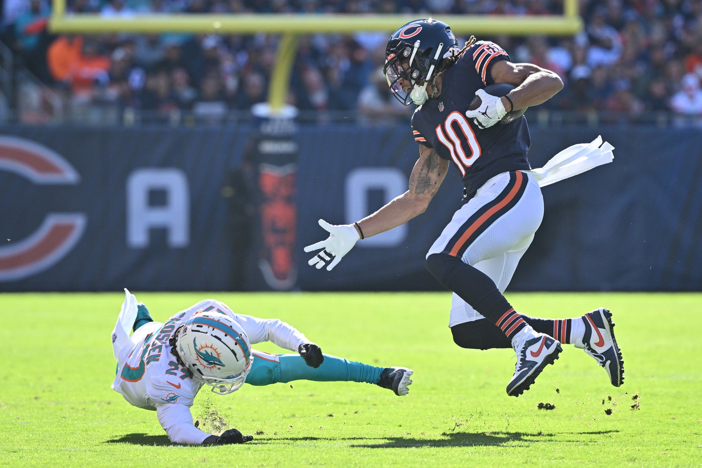 Nov 6, 2022; Chicago, Illinois, USA; Chicago Bears wide receiver Chase Claypool (10) avoids a tackle attempt from Miami Dolphins defensive back Keion Crossen (27) in the first quarter at Soldier Field. Mandatory Credit: Jamie Sabau-USA TODAY Sports