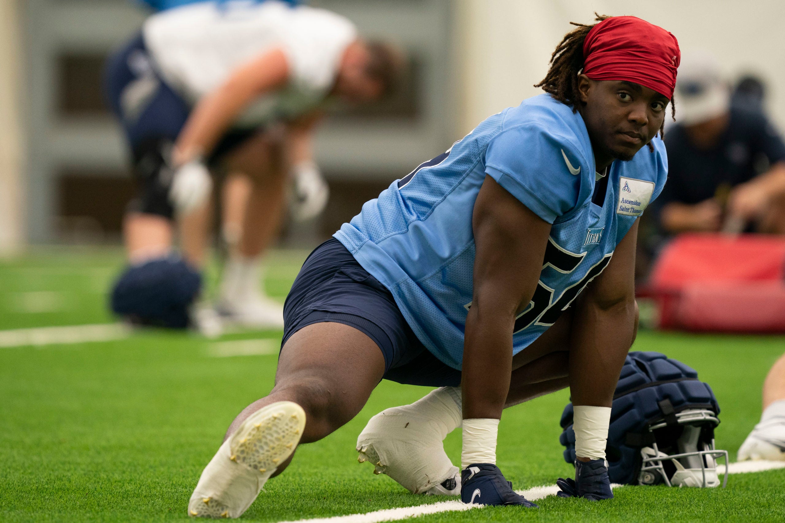 Jul 29, 2022; Nashville, Tennessee, USA;  Tennessee Titans outside linebacker David Anenih (54) stretches during a training camp practice at Saint Thomas Sports Park. Mandatory Credit: George Walker IV-USA TODAY Sports