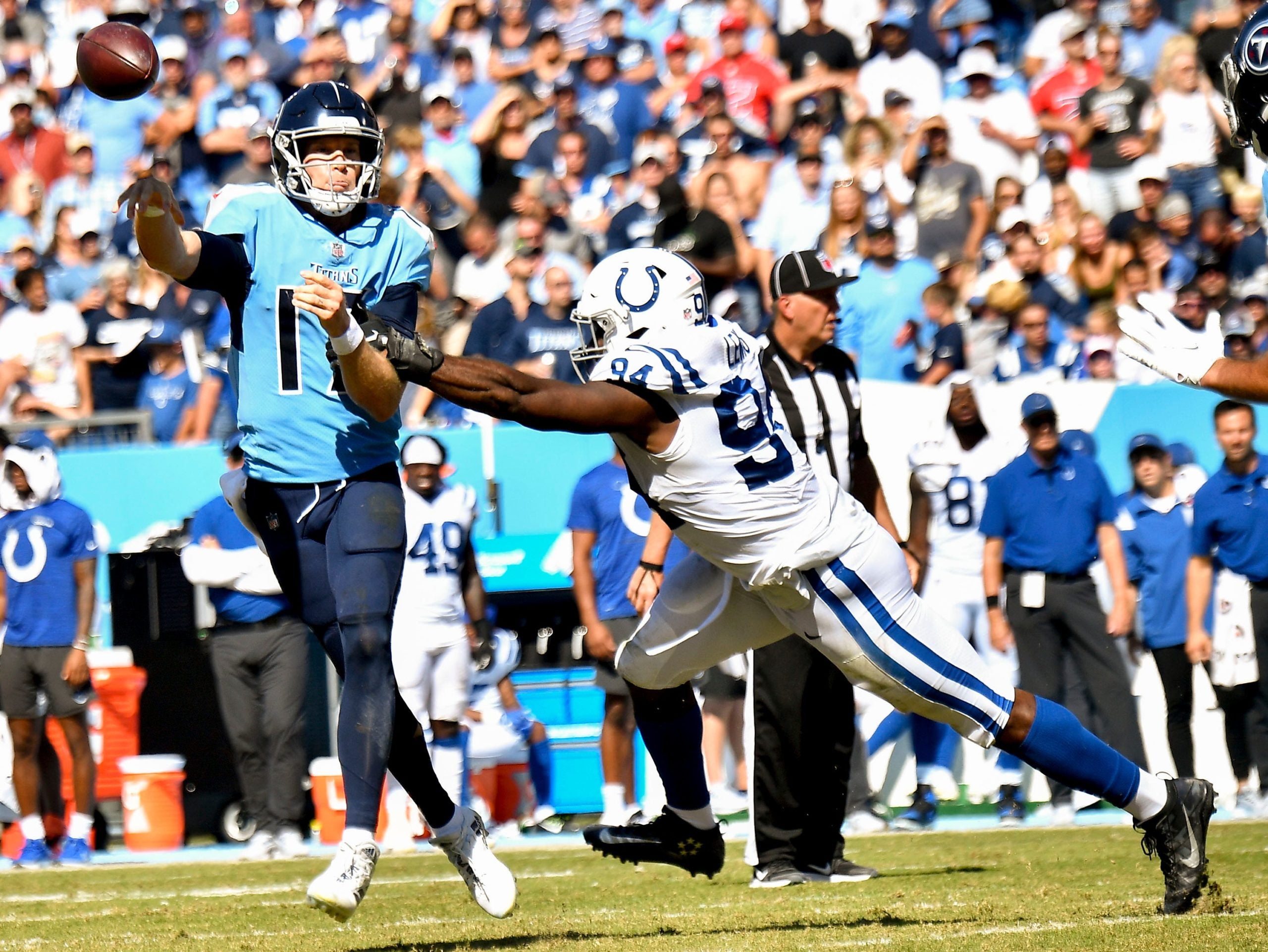 Tennessee Titans quarterback Ryan Tannehill (17) throws a pass under pressure from Indianapolis Colts defensive end Tyquan Lewis (94) during the fourth quarter at Nissan Stadium Sunday, Sept. 26, 2021 in Nashville, Tenn. Titans Colts 210