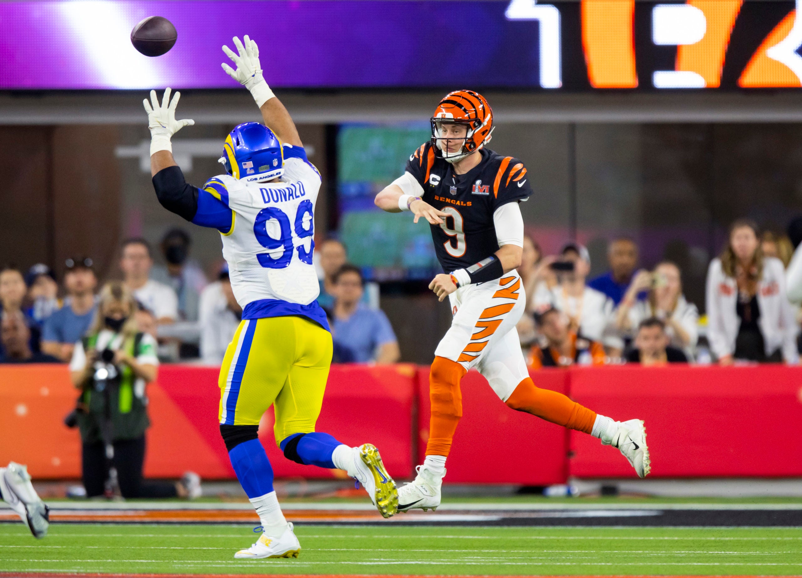 Feb 13, 2022; Inglewood, CA, USA; Cincinnati Bengals quarterback Joe Burrow (9) throws a pass against Los Angeles Rams defensive end Aaron Donald (99) in the fourth quarter of Super Bowl LVI at SoFi Stadium. Mandatory Credit: Mark J. Rebilas-USA TODAY Sports