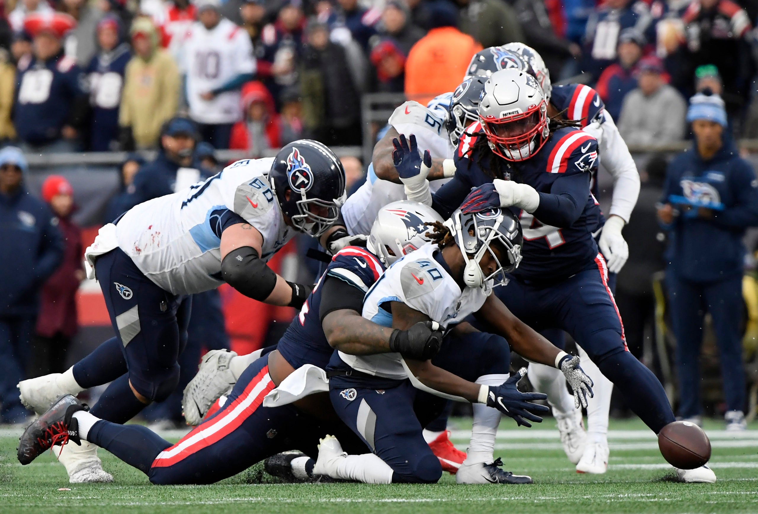Nov 28, 2021; Foxborough, Massachusetts, USA; Tennessee Titans running back Dontrell Hilliard (40) fumbles the ball during the first half against the New England Patriots at Gillette Stadium. Mandatory Credit: Bob DeChiara-USA TODAY Sports
