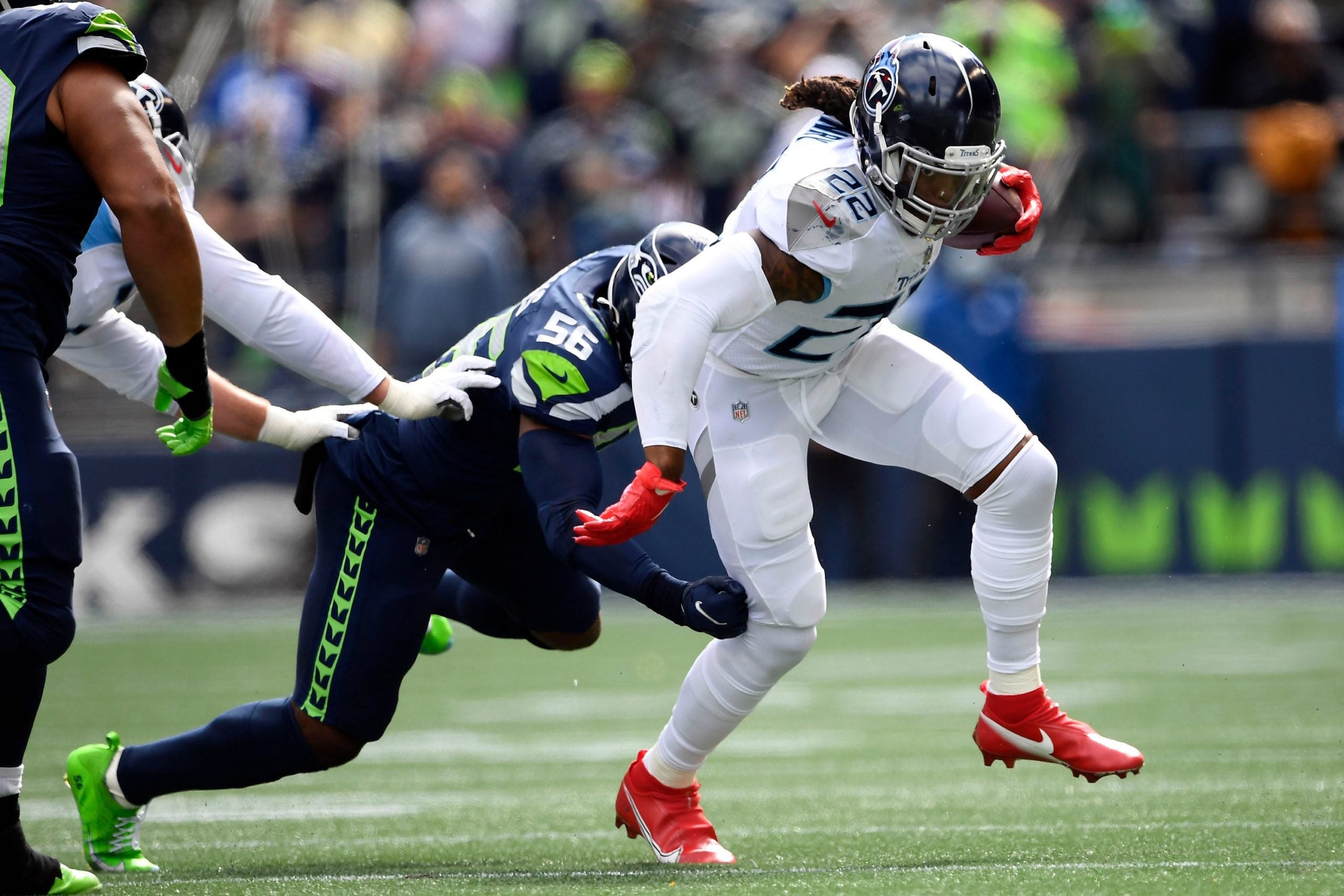 Tennessee Titans running back Derrick Henry (22) tries to get away from Seattle Seahawks linebacker Jordyn Brooks (56) during the first quarter at Lumen Field Sunday, Sept. 19, 2021 in Seattle, Wash. Titans Seahawks 047