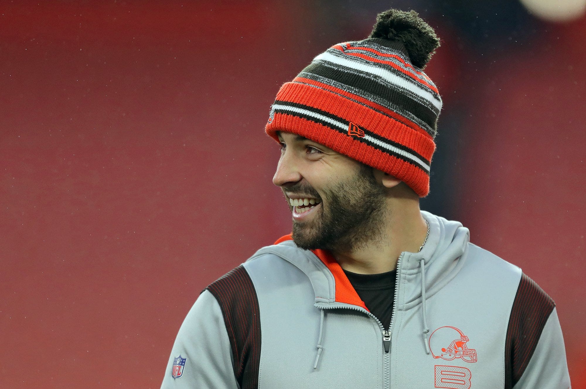 Browns quarterback Baker Mayfield laughs as he watches his teammates warm up before a game against the Cincinnati Bengals, Sunday, Jan. 9, 2022, in Cleveland. Baker Pregame 2