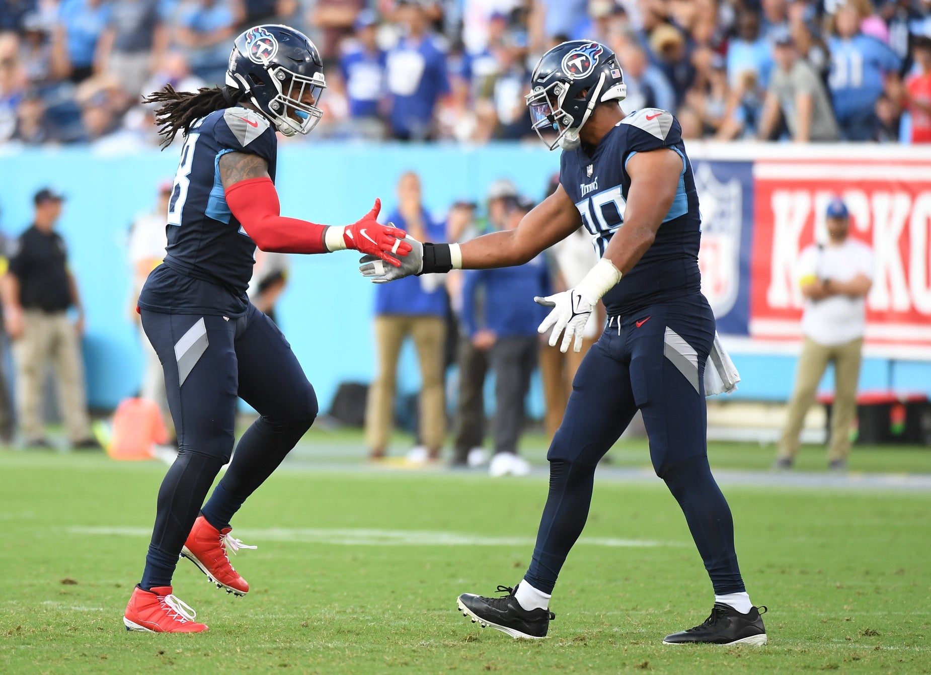 Sep 11, 2022; Nashville, Tennessee, USA; Tennessee Titans linebacker Bud Dupree (48) and linebacker Rashad Weaver (99) celebrate after a defensive stop during the second half against the New York Giants at Nissan Stadium. Mandatory Credit: Christopher Hanewinckel-USA TODAY Sports