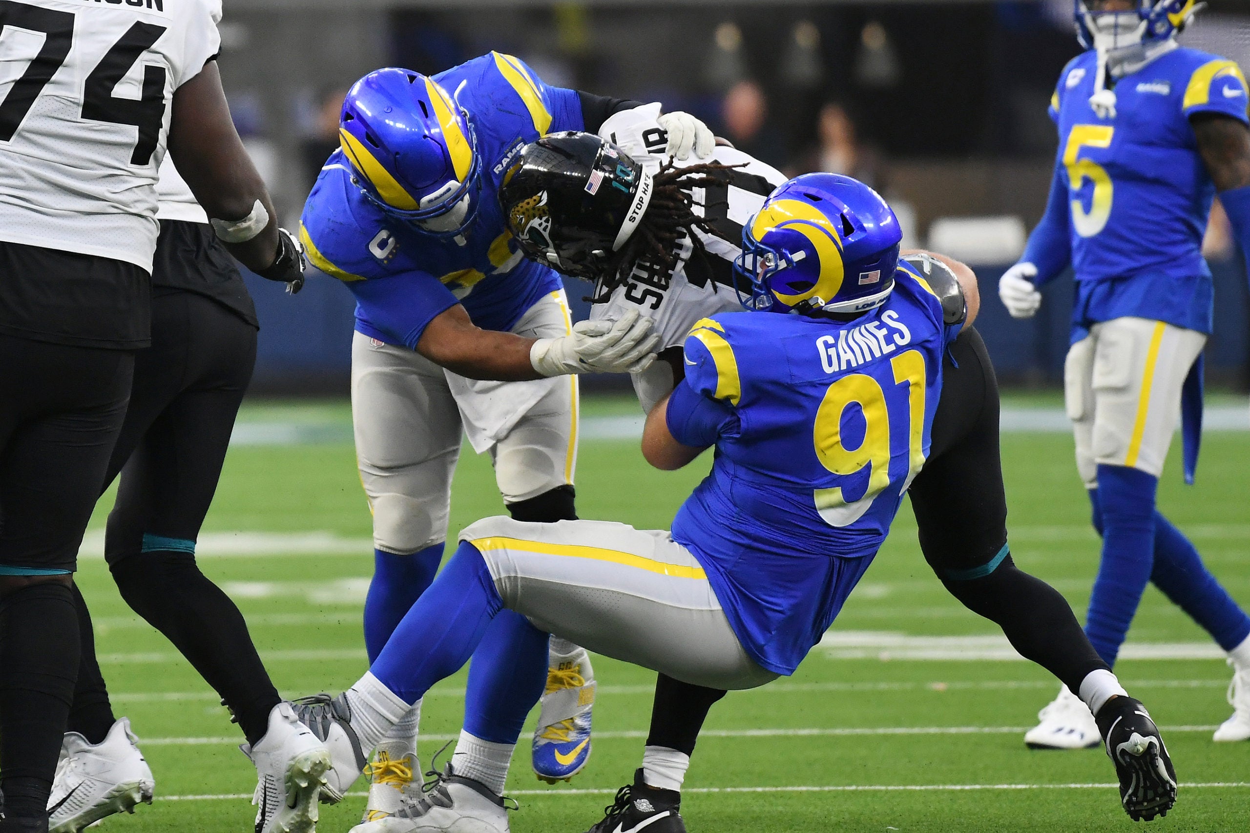 Dec 5, 2021; Inglewood, California, USA; Los Angeles Rams defensive end Aaron Donald (99) and defensive end Greg Gaines (91) tackle Jacksonville Jaguars wide receiver Laviska Shenault Jr. (10) in the fourth quarter  at SoFi Stadium. Mandatory Credit: Richard Mackson-USA TODAY Sports