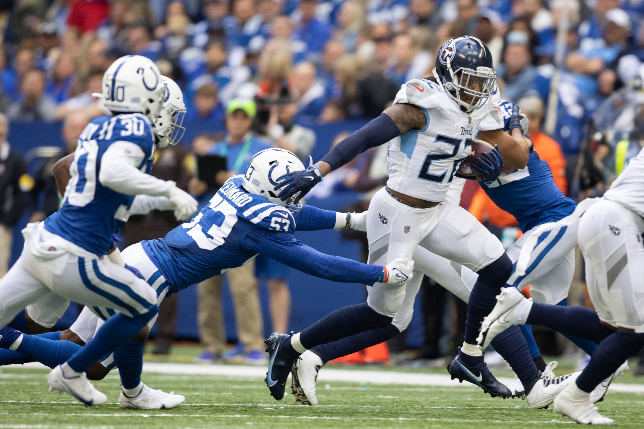 Oct 31, 2021; Indianapolis, Indiana, USA; Tennessee Titans running back Derrick Henry (22) runs the ball while Indianapolis Colts outside linebacker Darius Leonard (53) defends in the second half at Lucas Oil Stadium. Mandatory Credit: Trevor Ruszkowski-USA TODAY Sports