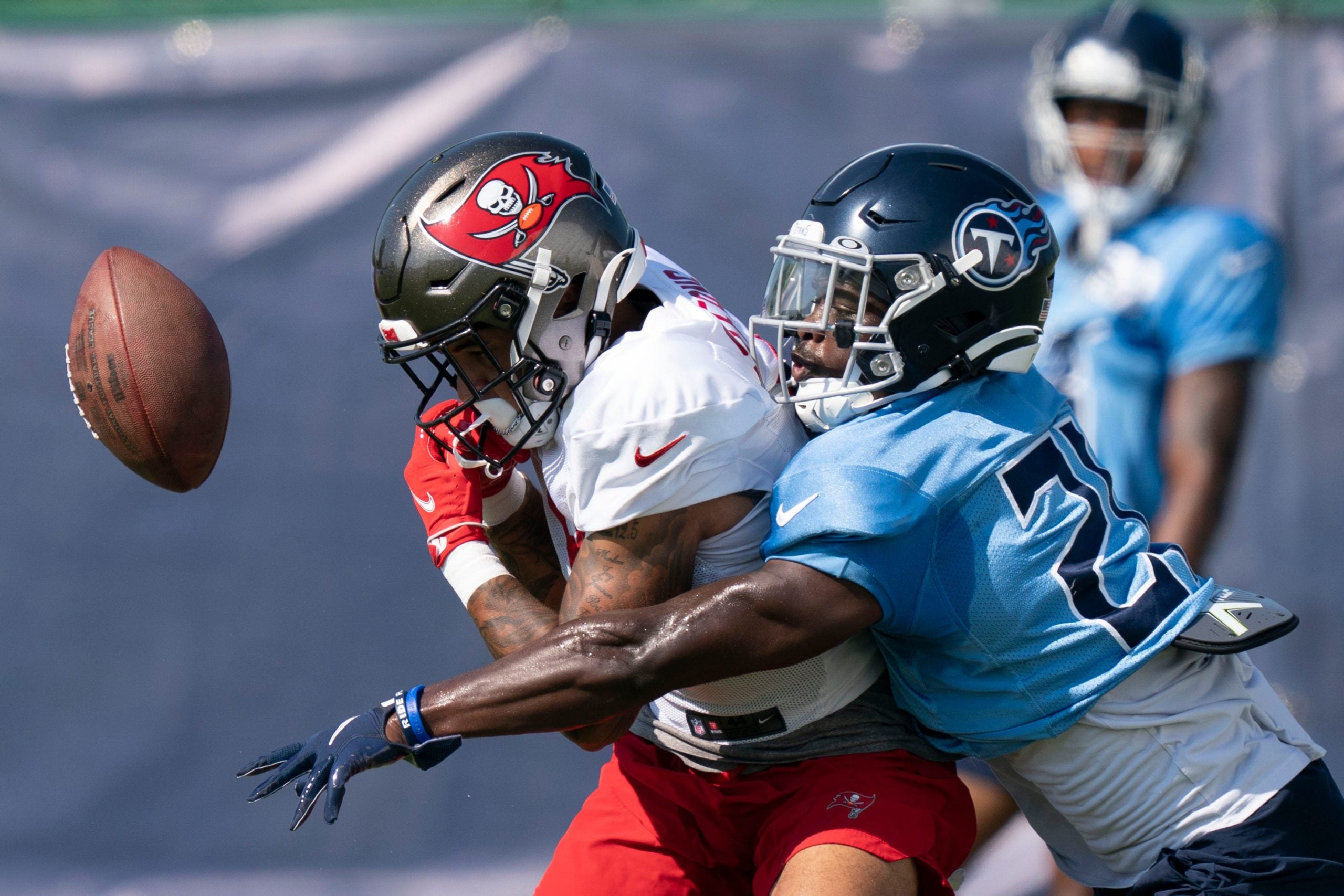 Tennessee Titans cornerback Roger McCreary (21) breaks up a pass intended for Tampa Bay Buccaneers wide receiver Jerreth Sterns (9) during a joint training camp practice at Ascension Saint Thomas Sports Park Thursday, Aug. 18, 2022, in Nashville, Tenn. Nas 0818 Titans Bucs 016