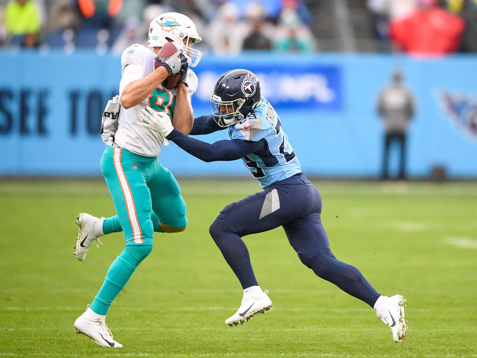 Jan 2, 2022; Nashville, Tennessee, USA; Miami Dolphins tight end Mike Gesicki (88) makes a catch over Tennessee Titans defensive back Dane Cruikshank (29) during the first half at Nissan Stadium. Mandatory Credit: Steve Roberts-USA TODAY Sports