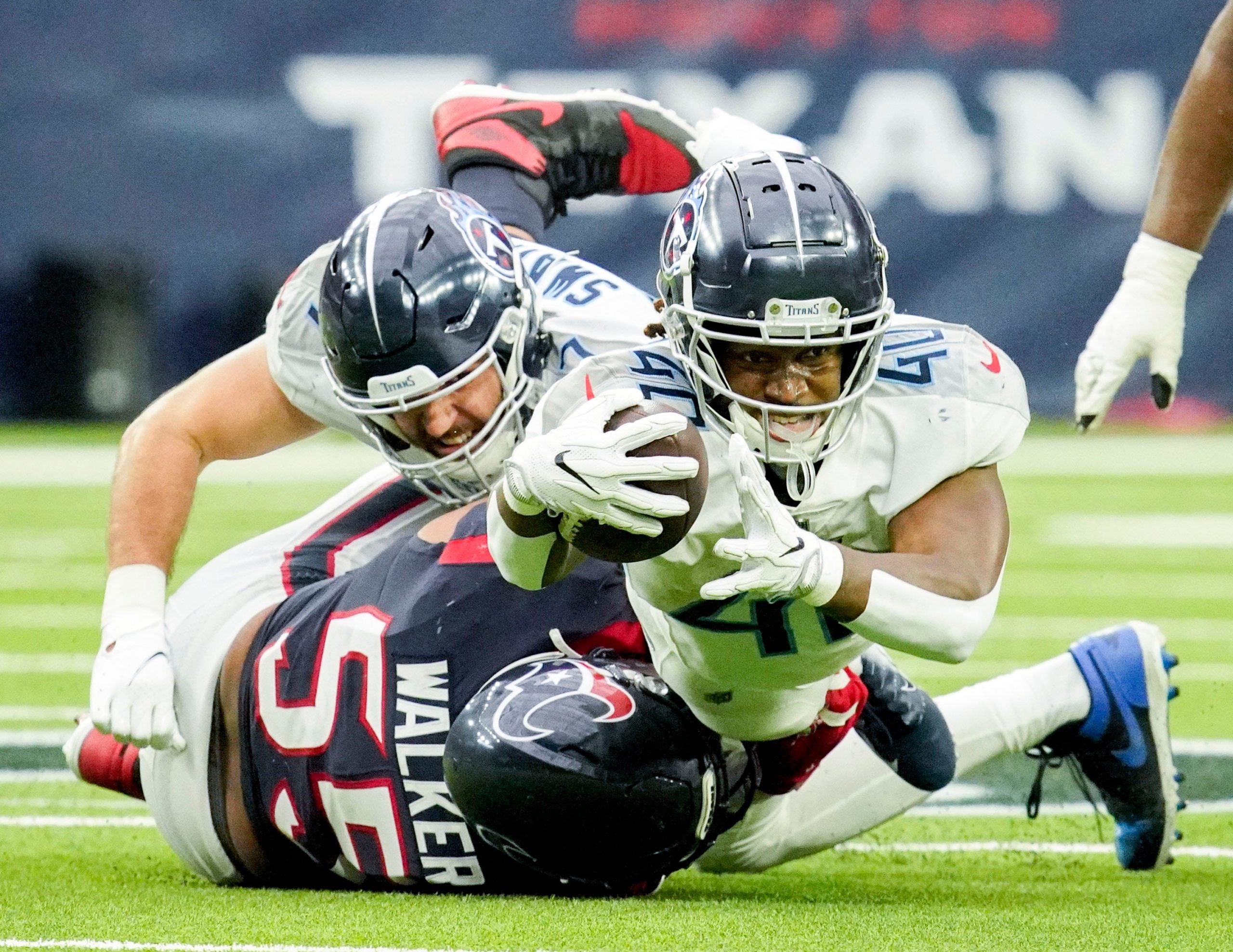 Tennessee Titans running back Dontrell Hilliard (40) dives for a first down during the fourth quarter at NRG Stadium Sunday, Jan. 9, 2022 in Houston, Texas. Titans Texans 117
