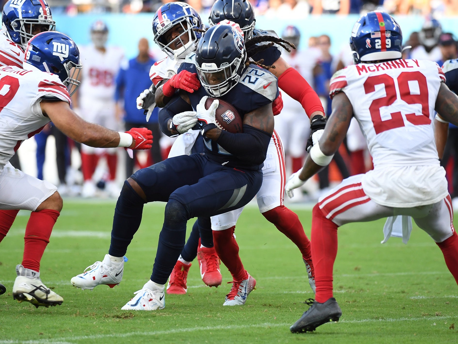 Sep 11, 2022; Nashville, Tennessee, USA; Tennessee Titans running back Derrick Henry (22) is tackled after a short gain during the second half against the New York Giants at Nissan Stadium. Mandatory Credit: Christopher Hanewinckel-USA TODAY Sports