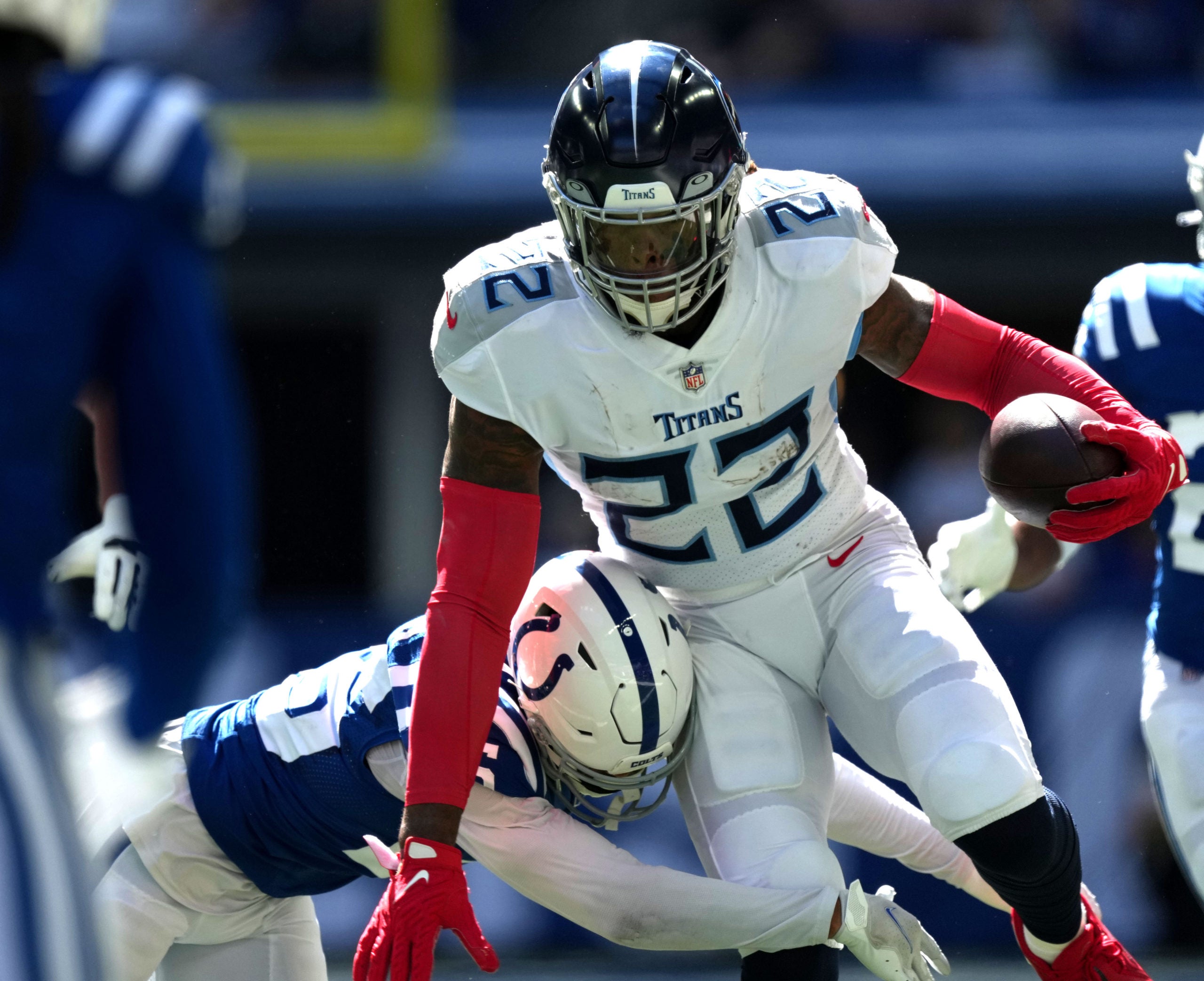 Oct 2, 2022; Indianapolis, Indiana, USA; Indianapolis Colts safety Rodney Thomas II (25) tackles Tennessee Titans running back Derrick Henry (22) during the first half at Lucas Oil Stadium. Mandatory Credit: Jenna Watson/IndyStar-USA TODAY NETWORK