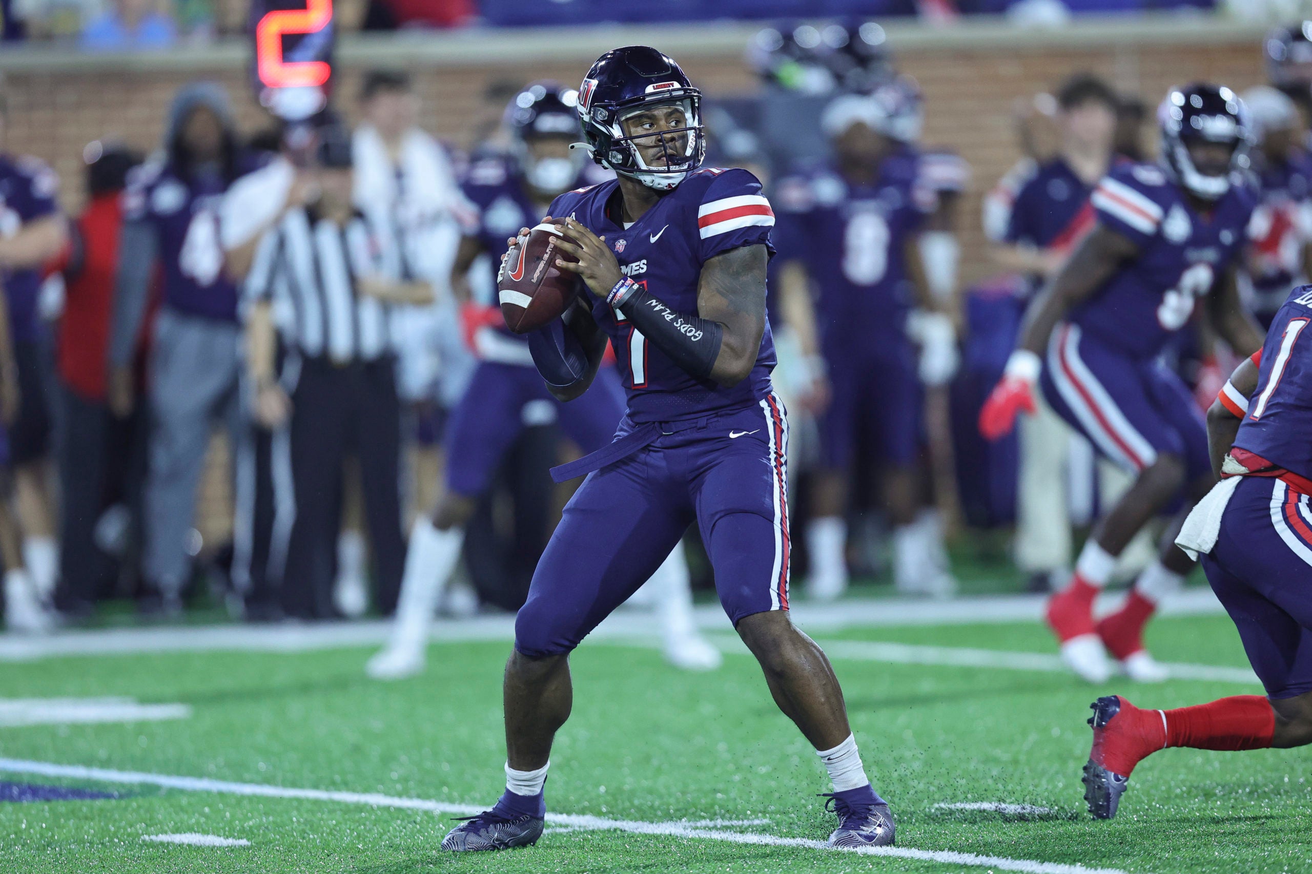 Dec 18, 2021; Mobile, Alabama, USA; Liberty Flames quarterback Malik Willis (7) sets up to pass in the first quarter against Eastern Michigan Eagles during the 2021 LendingTree Bowl at Hancock Whitney Stadium. Mandatory Credit: Robert McDuffie-USA TODAY Sports