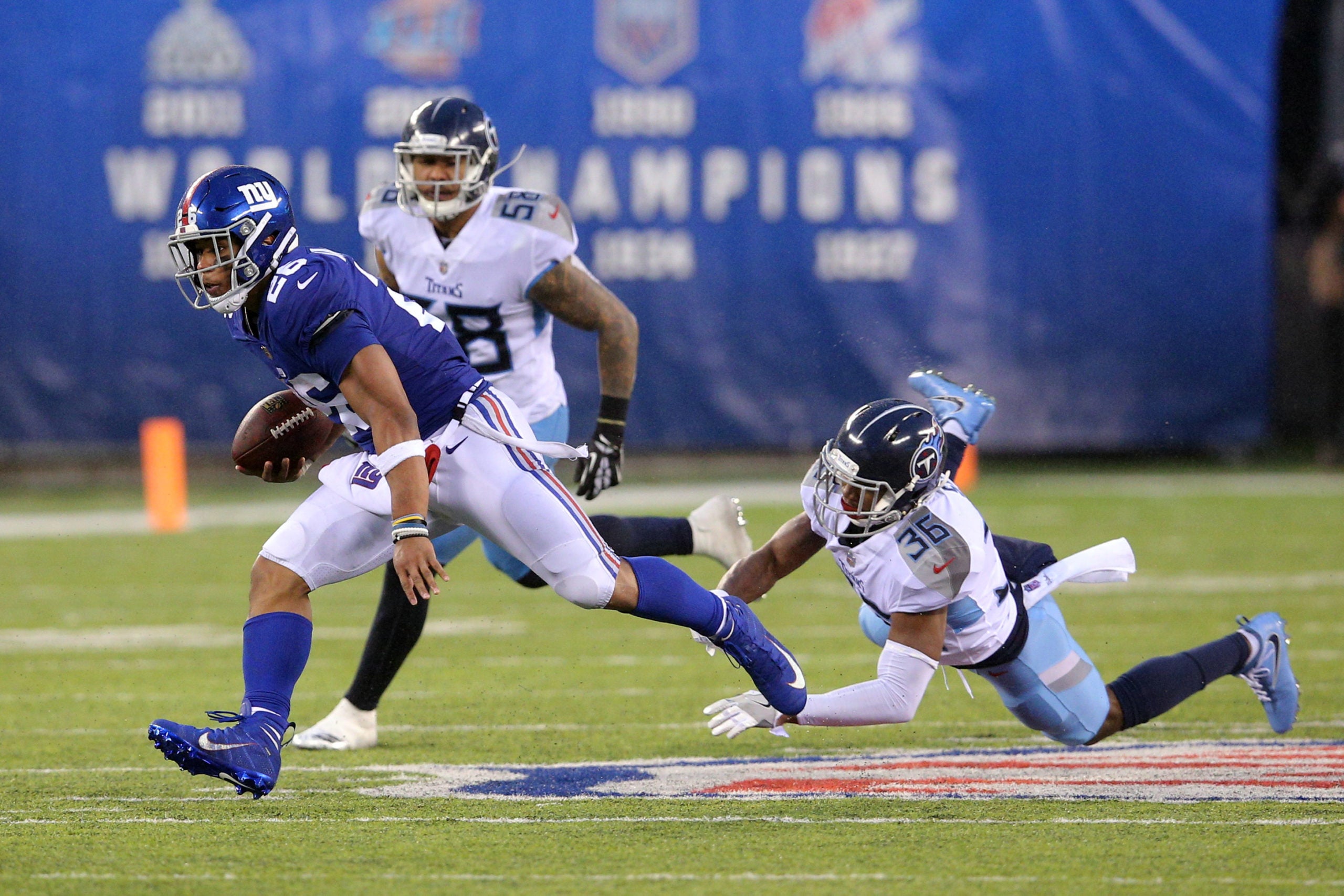 Dec 16, 2018; East Rutherford, NJ, USA; New York Giants running back Saquon Barkley (26) runs the ball against Tennessee Titans cornerback LeShaun Sims (36) during the fourth quarter at MetLife Stadium. Mandatory Credit: Brad Penner-USA TODAY Sports