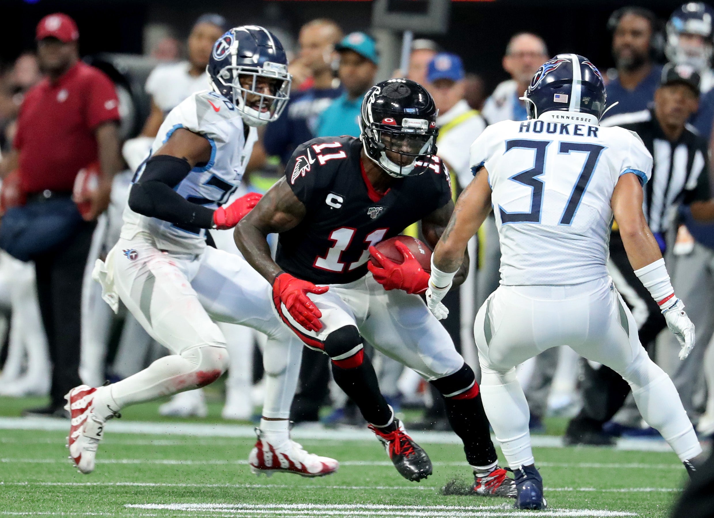 Sep 29, 2019; Atlanta, GA, USA; Atlanta Falcons wide receiver Julio Jones (11) runs after a catch against Tennessee Titans defensive back Amani Hooker (37) in the fourth quarter at Mercedes-Benz Stadium. Mandatory Credit: Jason Getz-USA TODAY Sports