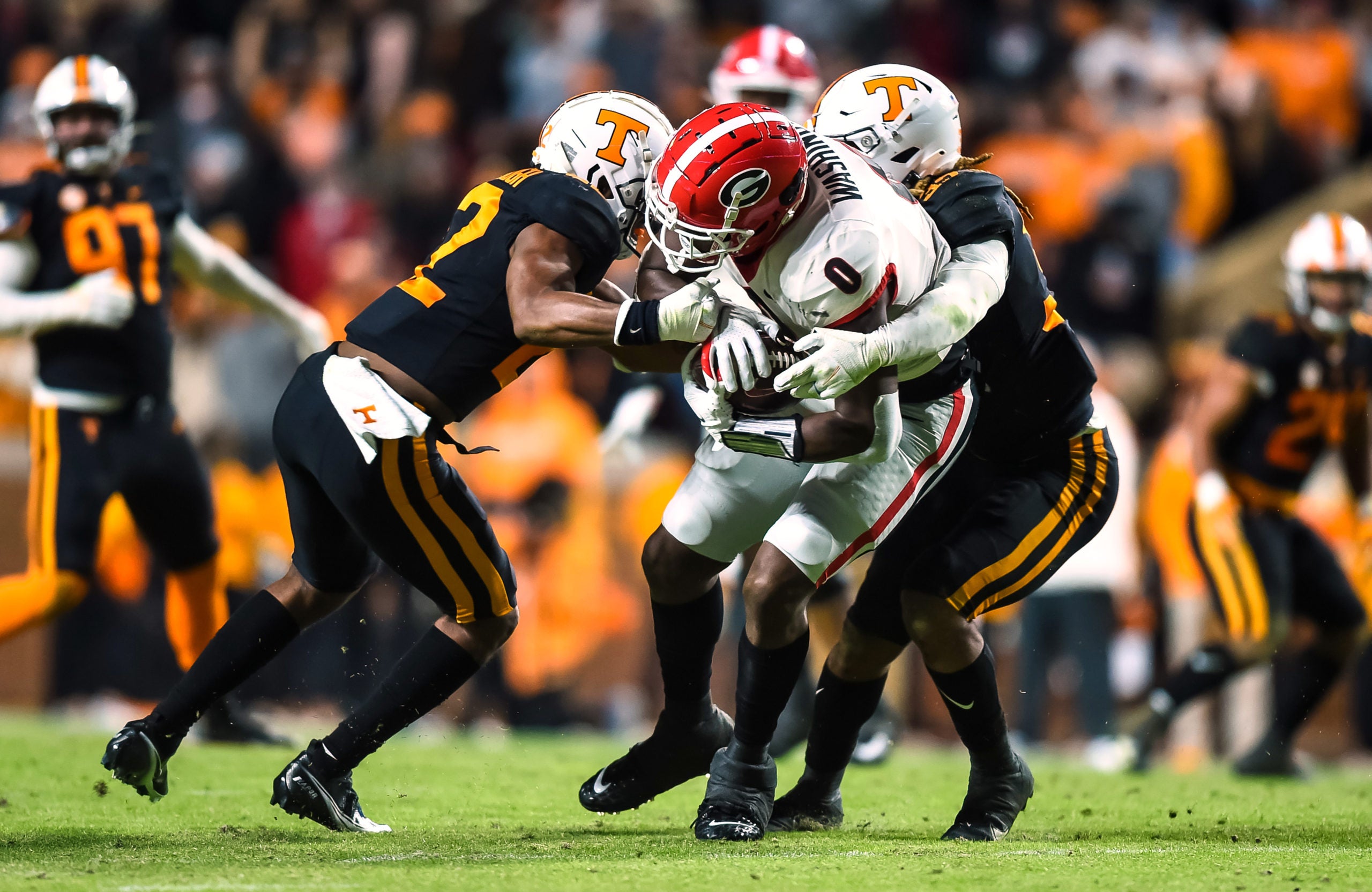 Nov 13, 2021; Knoxville, Tennessee, USA; Tennessee Volunteers defensive back Jaylen McCollough (22) and linebacker Jeremy Banks (33) tackle Georgia Bulldogs tight end Darnell Washington (0) during the second half at Neyland Stadium. Mandatory Credit: Bryan Lynn-USA TODAY Sports