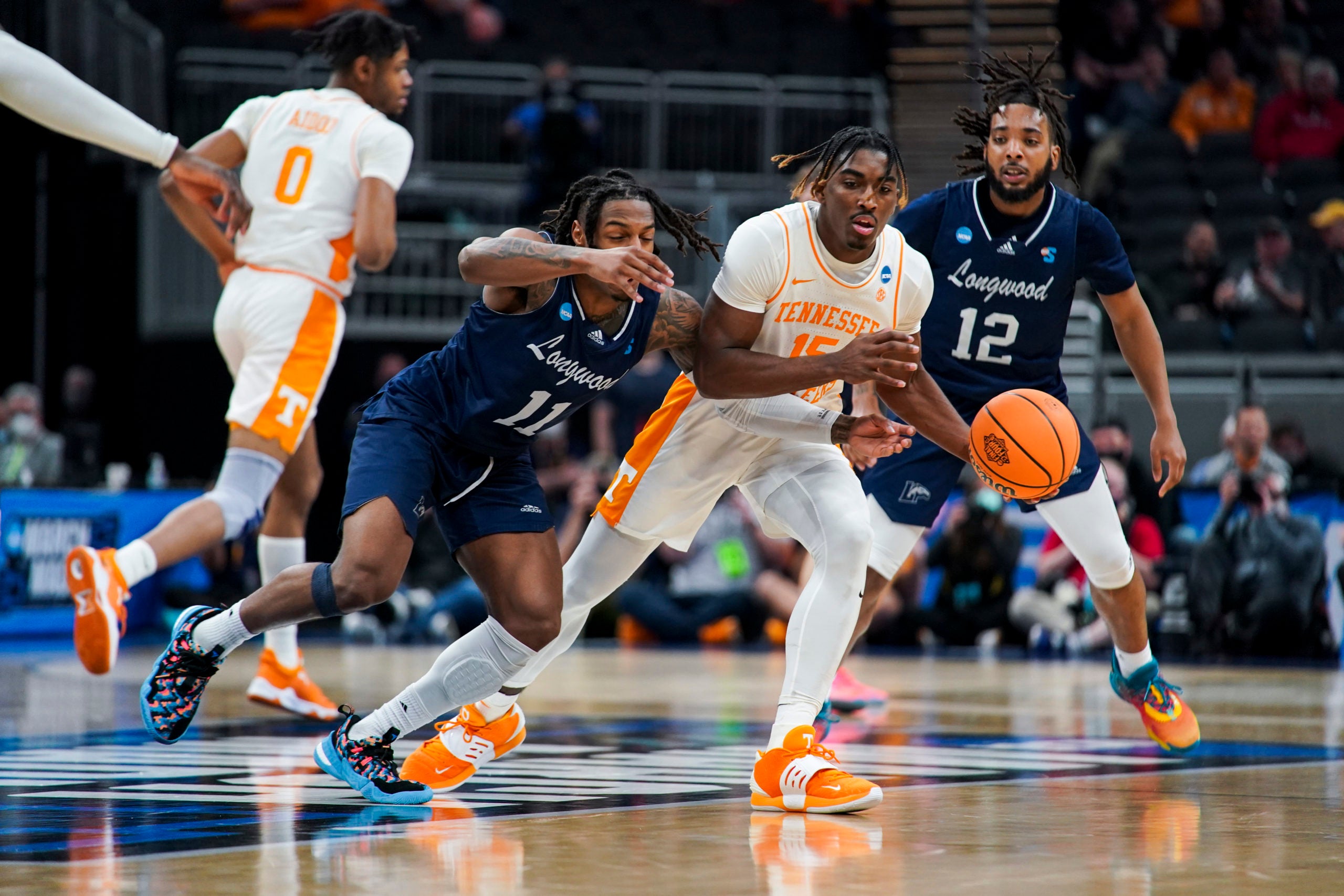 Mar 17, 2022; Indianapolis, IN, USA; Longwood Lancers guard Justin Hill (11) reaches for the ball against Tennessee Volunteers guard Jahmai Mashack (15) in the second half during the first round of the 2022 NCAA Tournament at Gainbridge Fieldhouse. Mandatory Credit: Robert Goddin-USA TODAY Sports