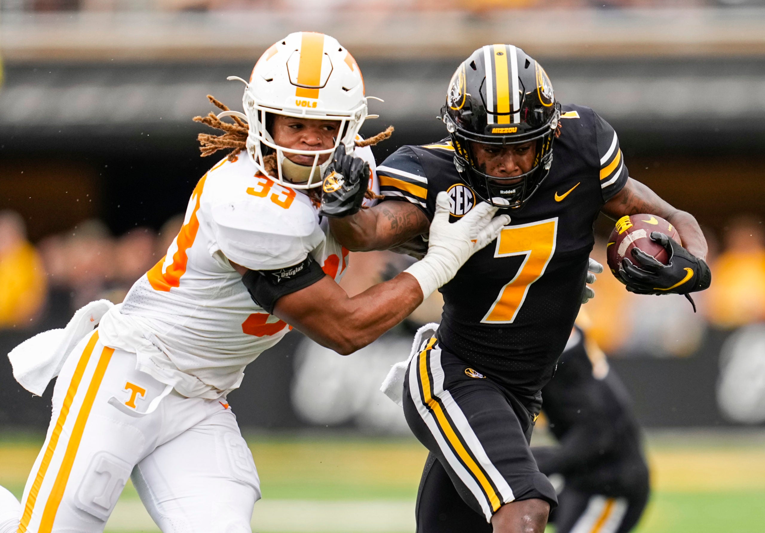 Oct 2, 2021; Columbia, Missouri, USA; Missouri Tigers wide receiver Dominic Lovett (7) stiff arms Tennessee Volunteers linebacker Jeremy Banks (33) during the first half at Faurot Field at Memorial Stadium. Mandatory Credit: Jay Biggerstaff-USA TODAY Sports