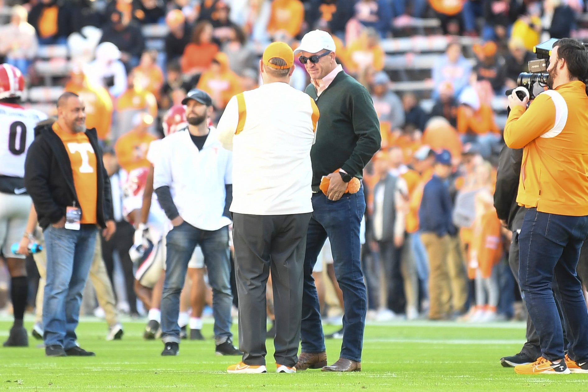 Peyton Manning talks to Josh Heupel on the field before an SEC football game between the Tennessee Volunteers and the Georgia Bulldogs in Neyland Stadium in Knoxville on Saturday, Nov. 13, 2021. Tennesseegeorgia1113 0798