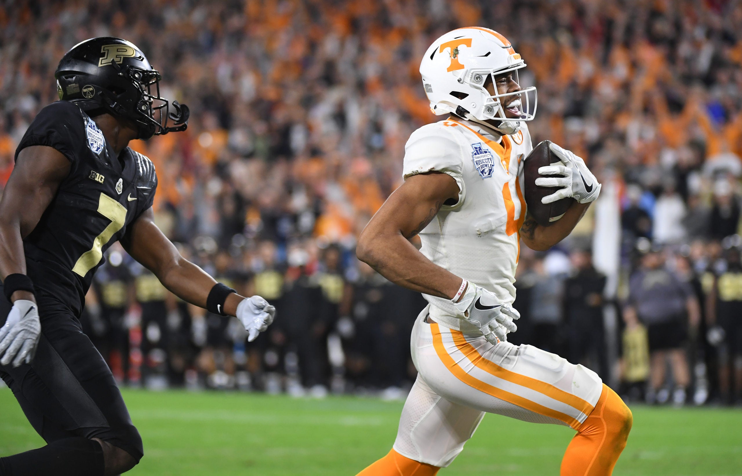 Dec 30, 2021; Nashville, TN, USA; Tennessee Volunteers wide receiver Cedric Tillman (4) runs in for a touchdown after a reception during the second half against the Purdue Boilermakers in the 2021 Music City Bowl at Nissan Stadium. Mandatory Credit: Christopher Hanewinckel-USA TODAY Sports