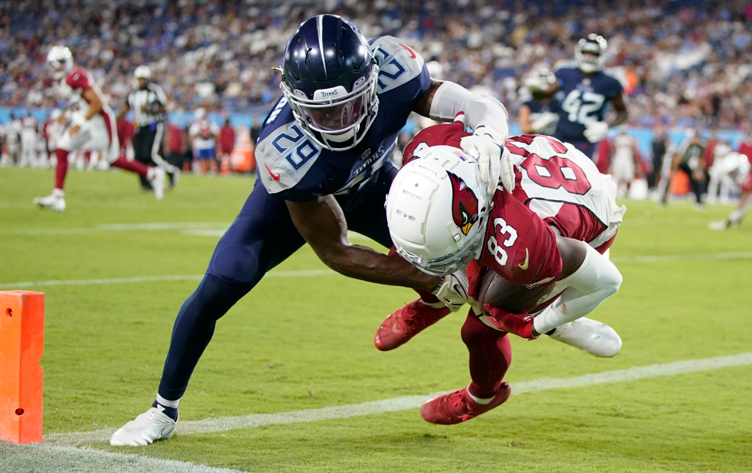 Aug 27, 2022; Nashville, Tennessee;  Arizona Cardinals wide receiver Greg Dortch (83) scores a touchdown against Tennessee Titans safety Theo Jackson (29) during the third quarter of a preseason game at Nissan Stadium. Mandatory Credit: Andrew Nelles-USA TODAY Sports
