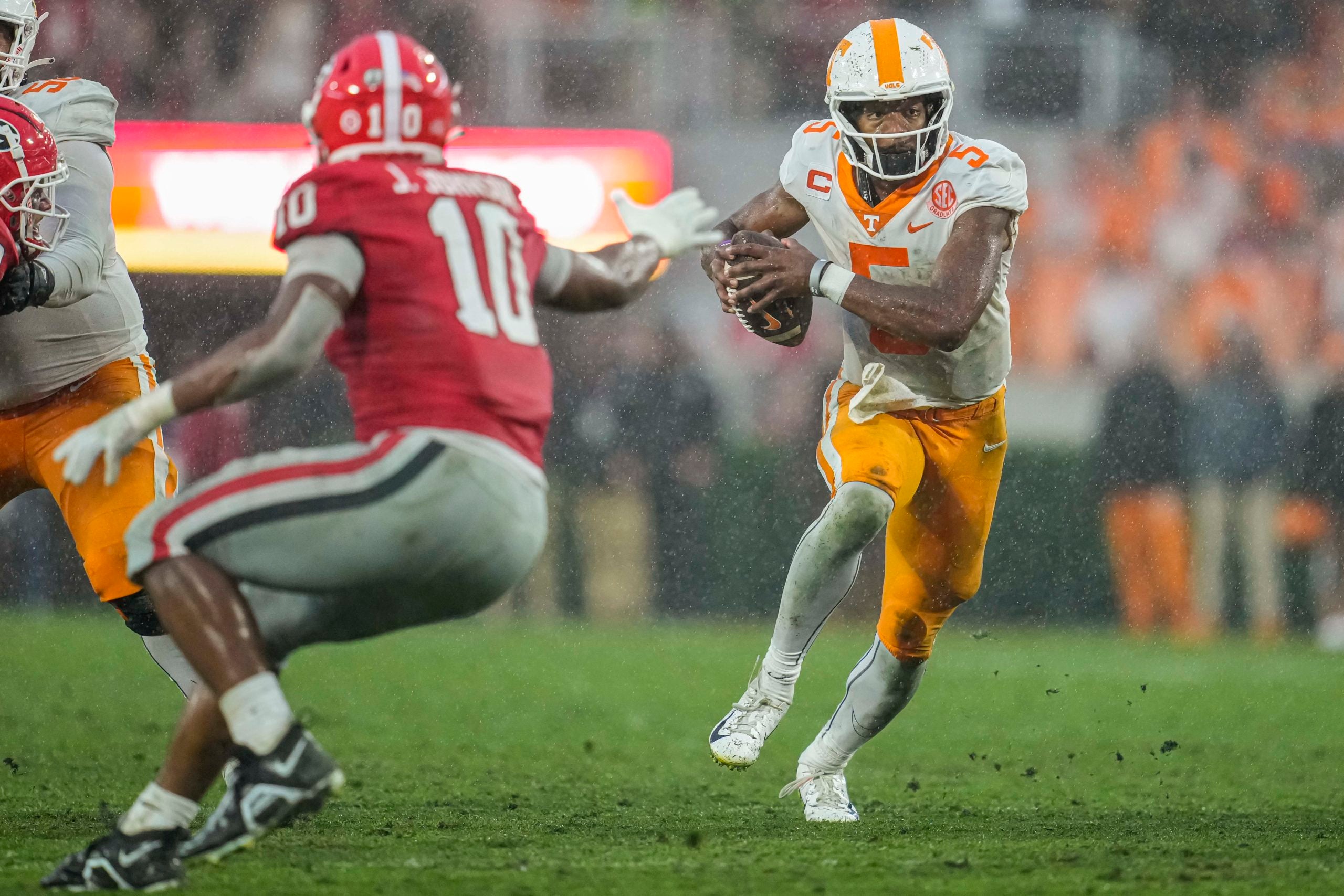 Nov 5, 2022; Athens, Georgia, USA; Tennessee Volunteers quarterback Hendon Hooker (5) runs against Tennessee Volunteers linebacker Juwan Mitchell (10) during the second half at Sanford Stadium. Mandatory Credit: Dale Zanine-USA TODAY Sports