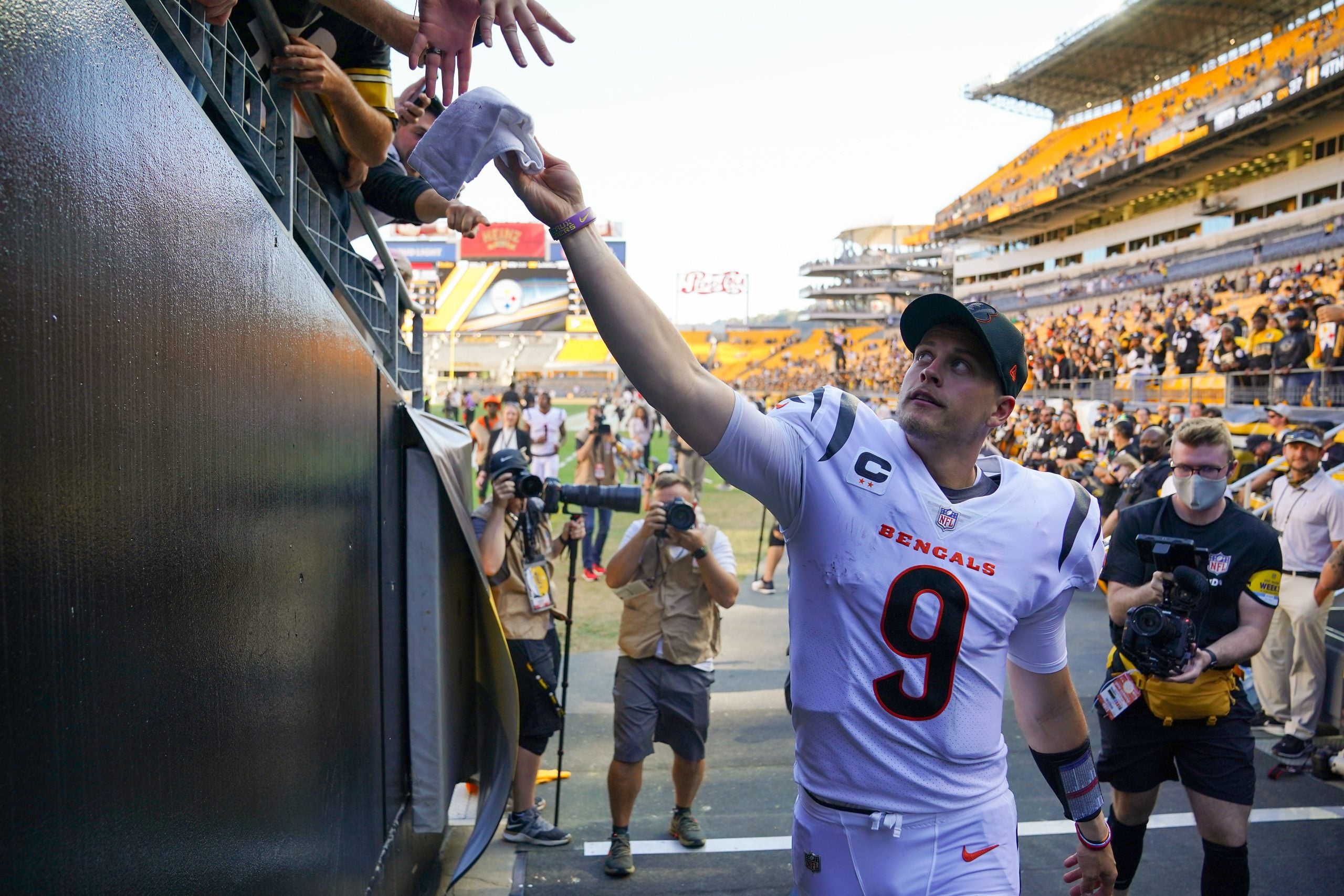 Cincinnati Bengals quarterback Joe Burrow (9) hands equipment to fans at the conclusion of a Week 3 NFL football game against the Pittsburgh Steelers, Sunday, Sept. 26, 2021, at Heinz Field in Pittsburgh. Cincinnati Bengals At Pittsburgh Steelers Sept 26