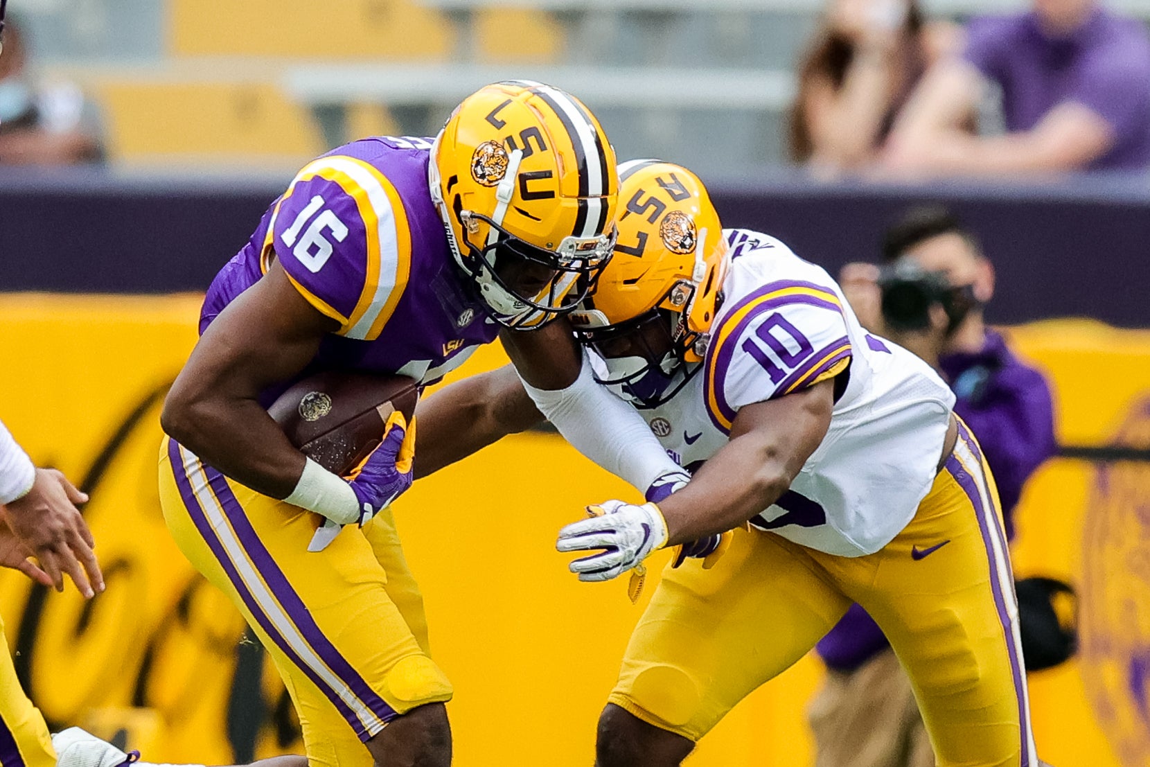 Apr 17, 2021; Baton Rouge, Louisiana, USA;  LSU Tigers linebacker Josh White (10) tackles LSU Tigers tight end Devonta Lee (16) during the first half of the annual Purple and White spring game at Tiger Stadium. Mandatory Credit: Stephen Lew-USA TODAY Sports