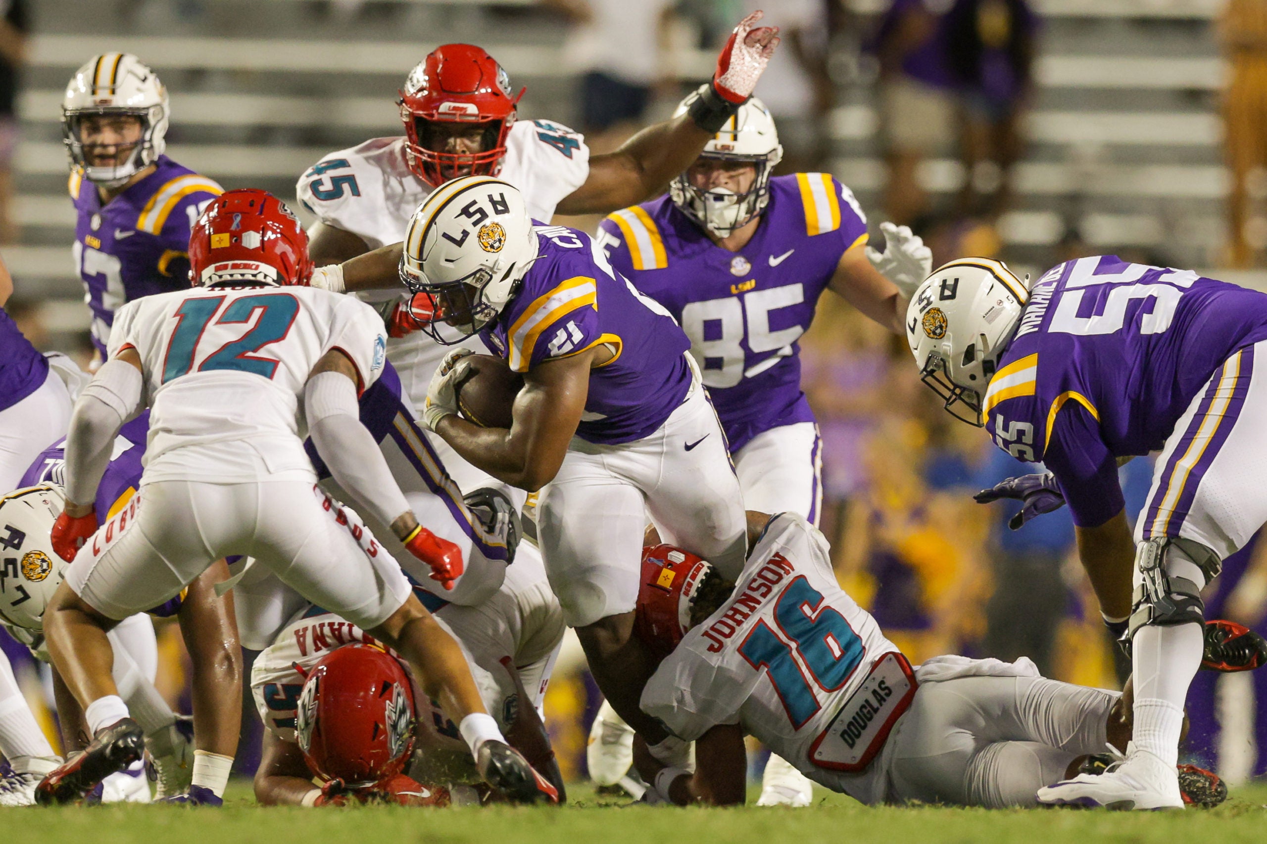 Sep 24, 2022; Baton Rouge, Louisiana, USA; LSU Tigers running back Noah Cain (21) is tackled by New Mexico Lobos safety Benji Johnson (16) during the second half at Tiger Stadium. Mandatory Credit: Stephen Lew-USA TODAY Sports