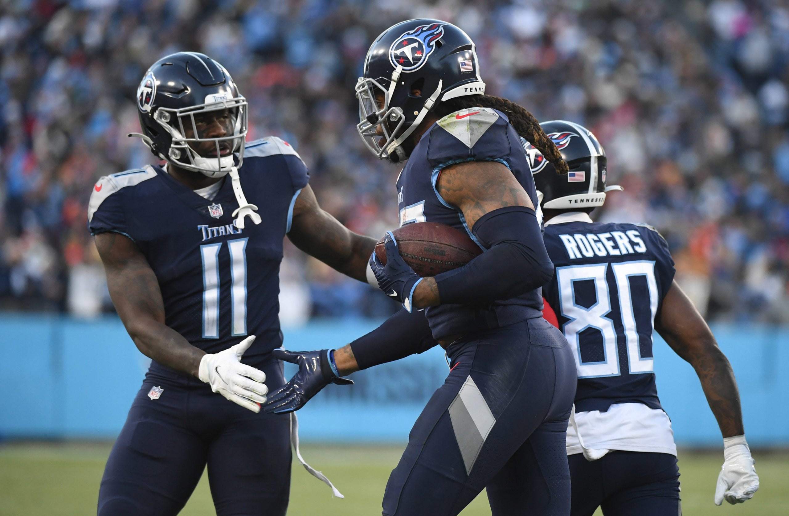 Jan 22, 2022; Nashville, Tennessee, USA; Tennessee Titans wide receiver A.J. Brown (11) celebrates with Tennessee Titans running back Derrick Henry (22) after a touchdown during the first half against the Cincinnati Bengals during a AFC Divisional playoff football game at Nissan Stadium. Mandatory Credit: Christopher Hanewinckel-USA TODAY Sports