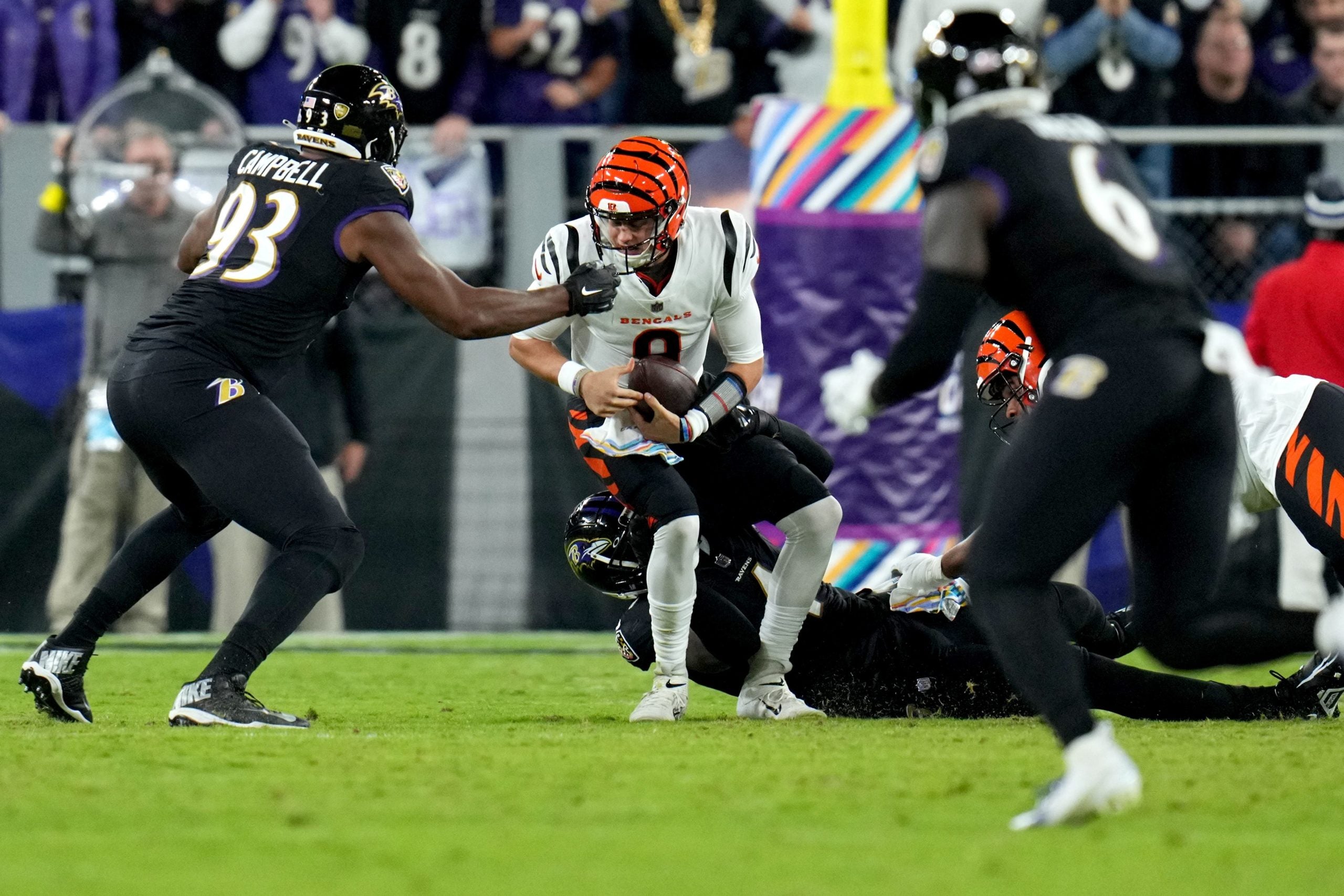 Cincinnati Bengals quarterback Joe Burrow (9) is sacked by Baltimore Ravens linebacker Jason Pierre-Paul (4) in the first quarter during an NFL Week 5 game, Sunday, Oct. 9, 2022, at M&T Bank Stadium in Baltimore. Nfl Cincinnati Bengals At Baltimore Ravens Oct 9 0136
