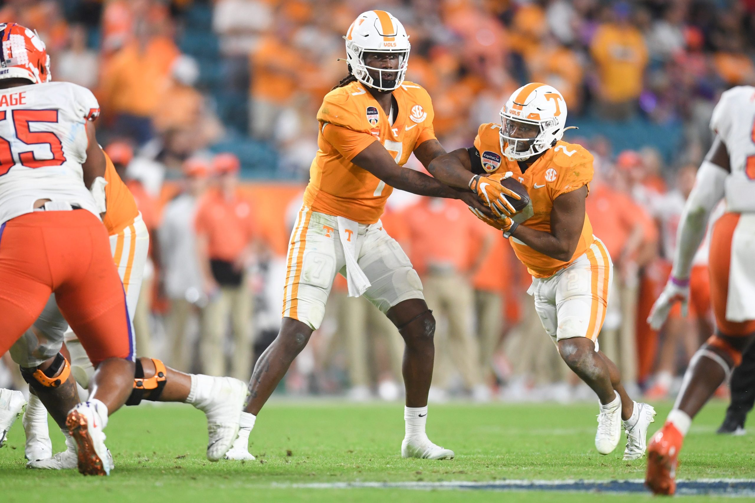 Tennessee quarterback Joe Milton III (7) hands the ball off to Tennessee running back Jabari Small (2) during the Orange Bowl game between the Tennessee Vols and Clemson Tigers at Hard Rock Stadium in Miami Gardens, Fla. on Friday, Dec. 30, 2022. Tennessee defeated Clemson 31-14. Orangebowl1230 4125