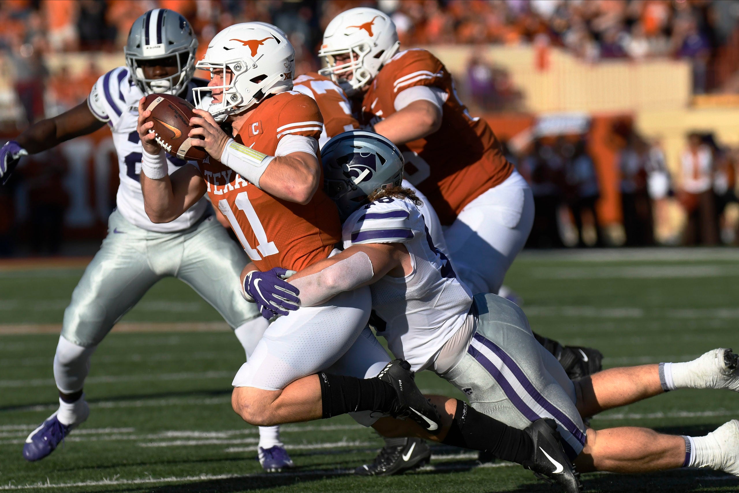 Nov 9, 2019; Austin, TX, USA; Kansas Jayhawks defensive end Wyatt Hubert (56) sacks Texas Longhorns quarterback Sam Ehlinger (11) in the first half at Darrell K Royal-Texas Memorial Stadium. Mandatory Credit: Scott Wachter-USA TODAY Sports