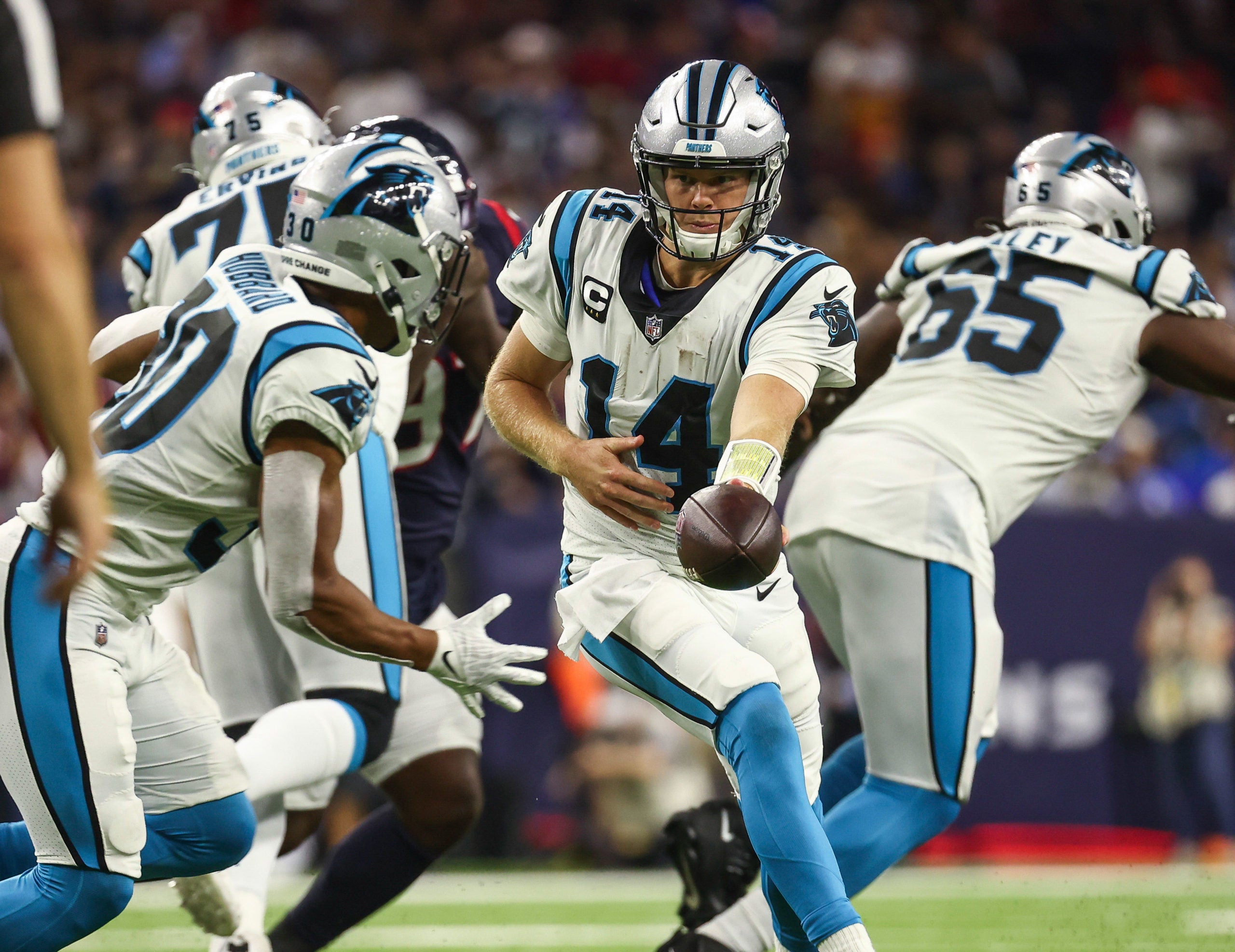 Sep 23, 2021; Houston, Texas, USA; Carolina Panthers quarterback Sam Darnold (14) hands off to running back Chuba Hubbard (30) during the game against the Houston Texans at NRG Stadium. Mandatory Credit: Troy Taormina-USA TODAY Sports
