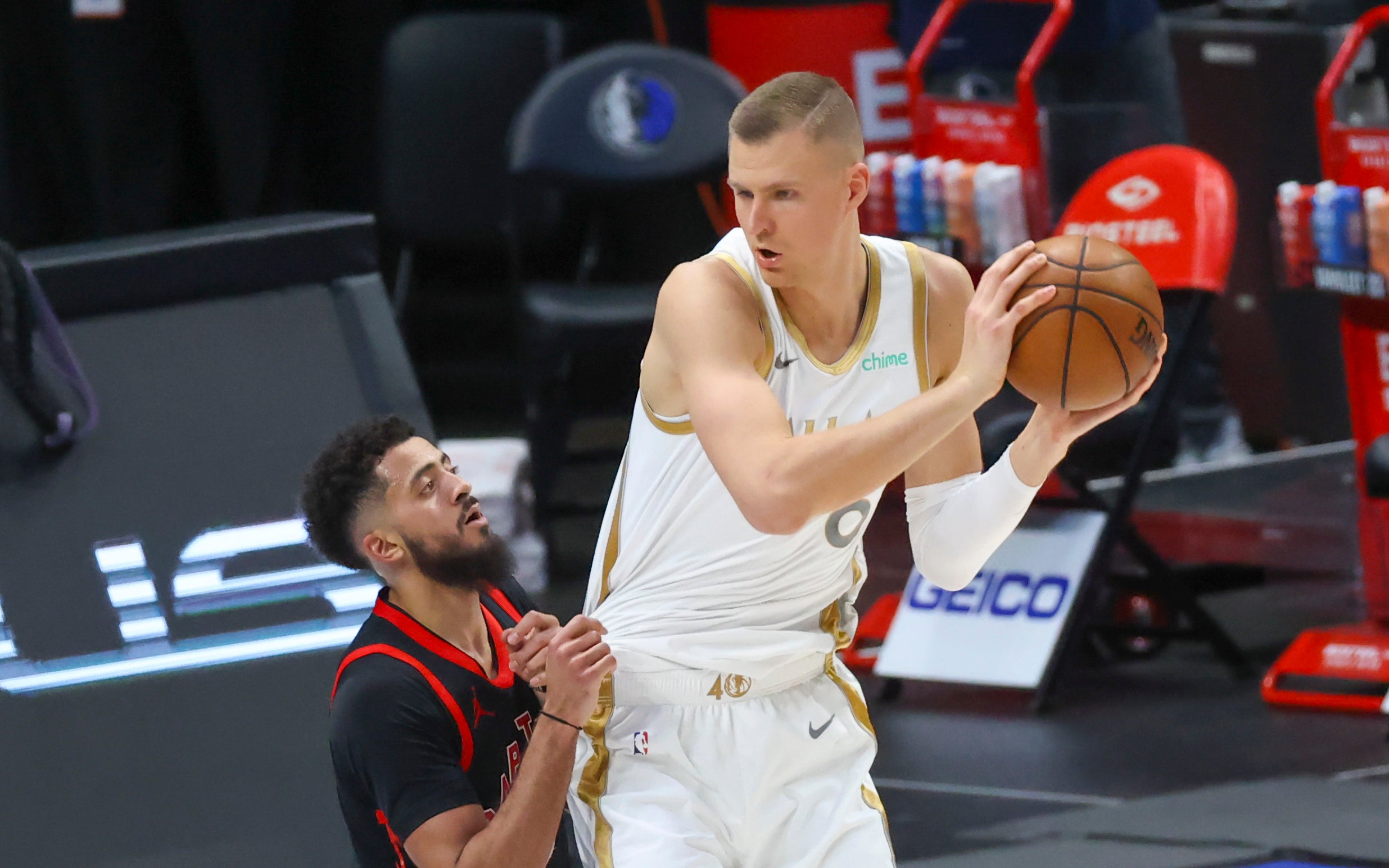 May 14, 2021; Dallas, Texas, USA; Dallas Mavericks center Kristaps Porzingis (6) looks to shoot as Toronto Raptors guard Jalen Harris (2) defends during the third quarter at American Airlines Center. Mandatory Credit: Kevin Jairaj-USA TODAY Sports