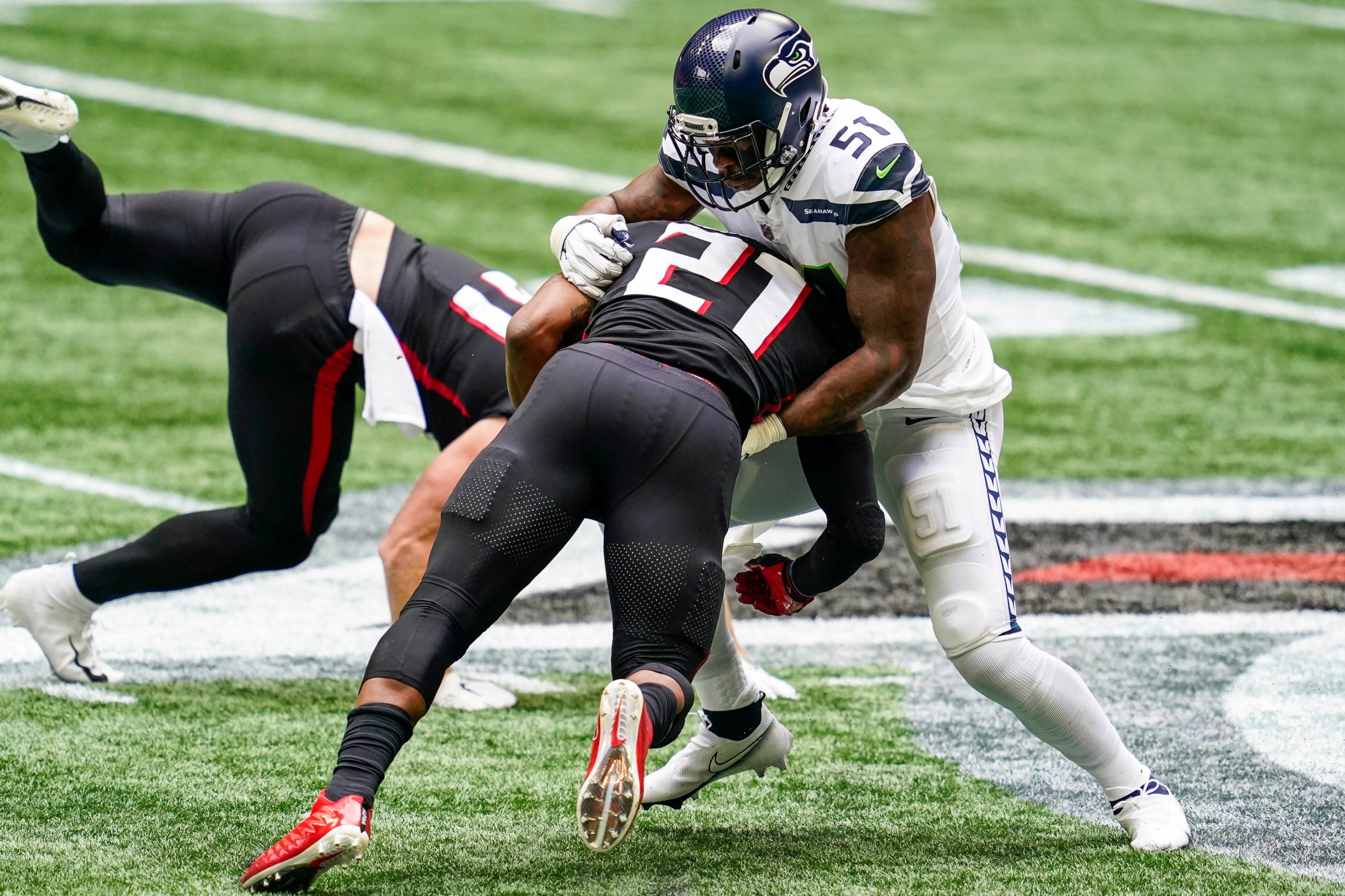 Sep 13, 2020; Atlanta, Georgia, USA; Seattle Seahawks linebacker Bruce Irvin (51) tackles Atlanta Falcons running back Todd Gurley (21) during the first half at Mercedes-Benz Stadium. Mandatory Credit: Dale Zanine-USA TODAY Sports