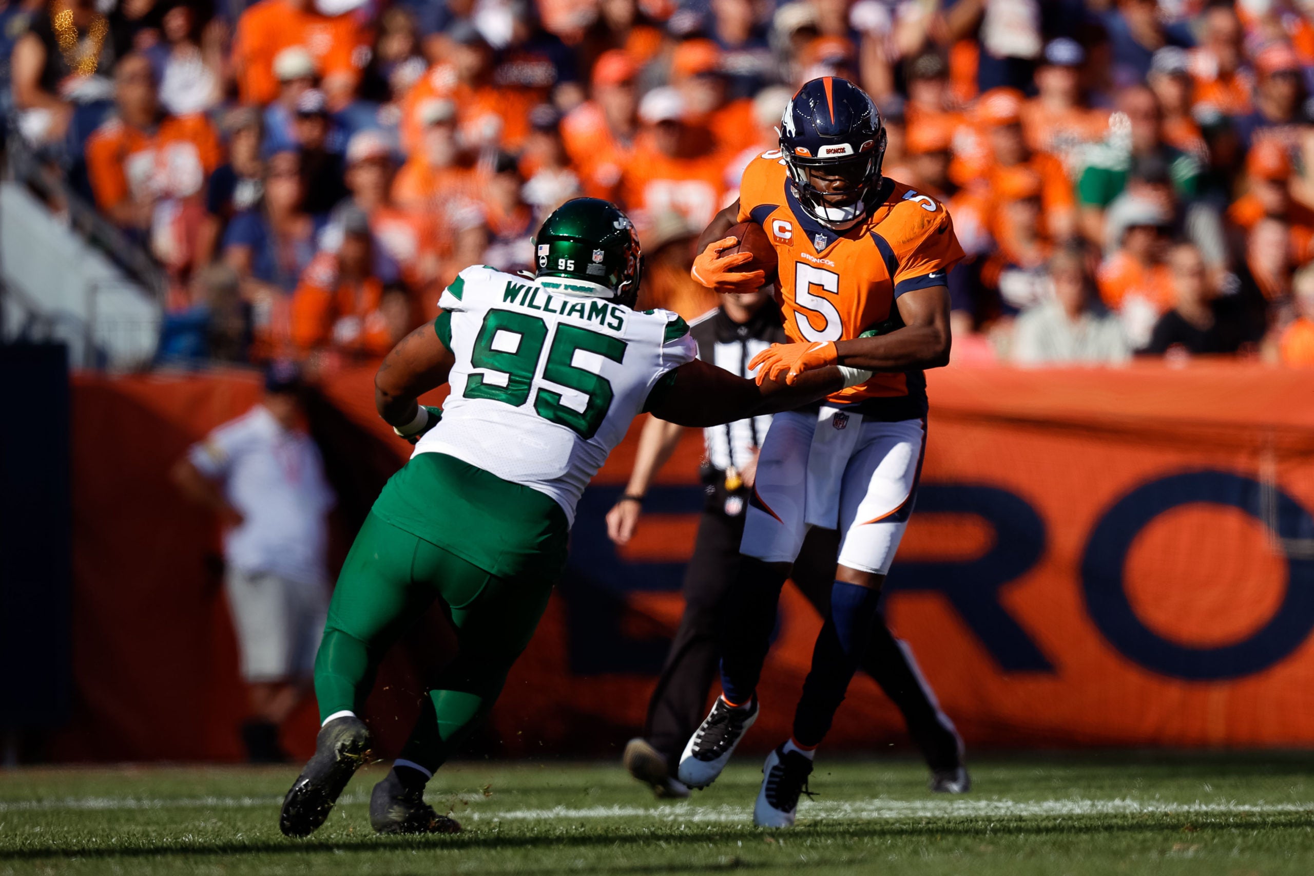 Sep 26, 2021; Denver, Colorado, USA; Denver Broncos quarterback Teddy Bridgewater (5) runs the ball against New York Jets defensive tackle Quinnen Williams (95) in the third quarter at Empower Field at Mile High. Mandatory Credit: Isaiah J. Downing-USA TODAY Sports