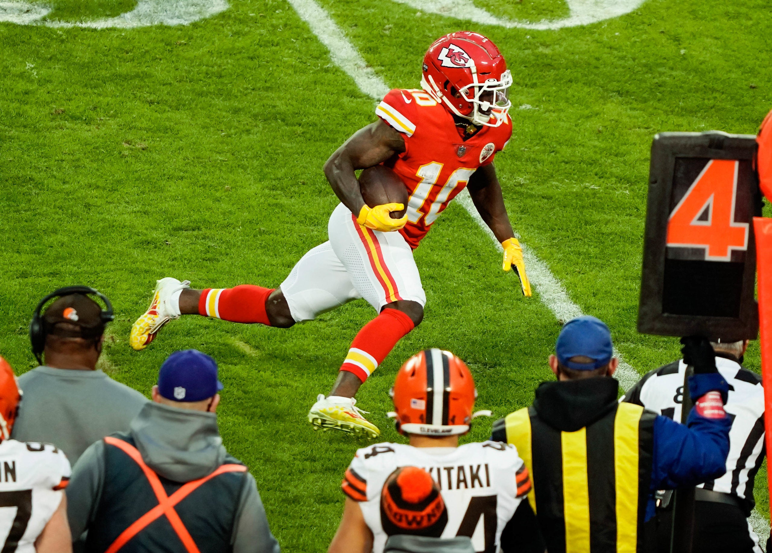 Jan 17, 2021; Kansas City, Missouri, USA; Kansas City Chiefs wide receiver Tyreek Hill (10) runs for a first down in the second half against the Cleveland Browns during an AFC Divisional Round playoff game at Arrowhead Stadium. Mandatory Credit: Jay Biggerstaff-USA TODAY Sports