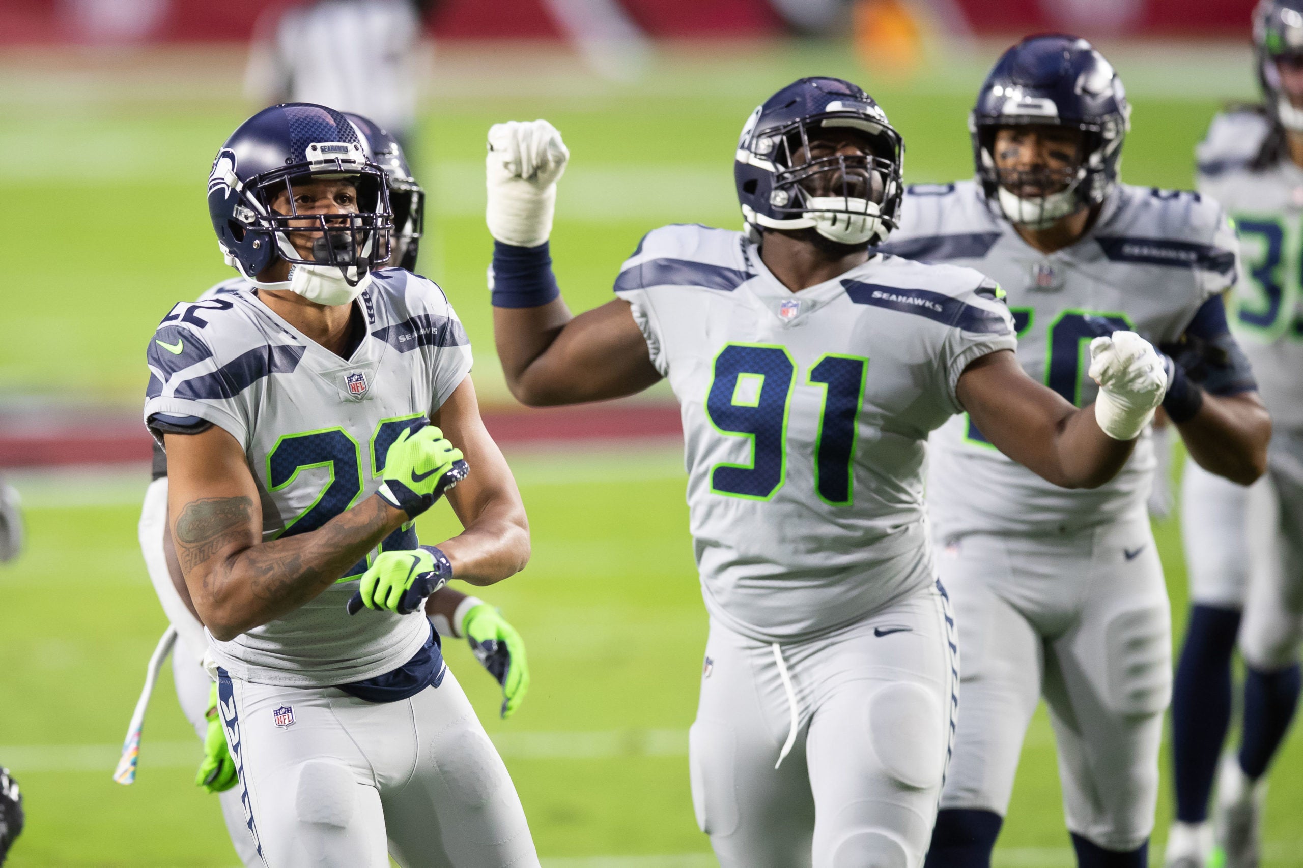 Oct 25, 2020; Glendale, Arizona, USA; Seattle Seahawks cornerback Quinton Dunbar (22) and defensive end L.J. Collier (91) react against the Arizona Cardinals in the first quarter at State Farm Stadium. Mandatory Credit: Billy Hardiman-USA TODAY Sports
